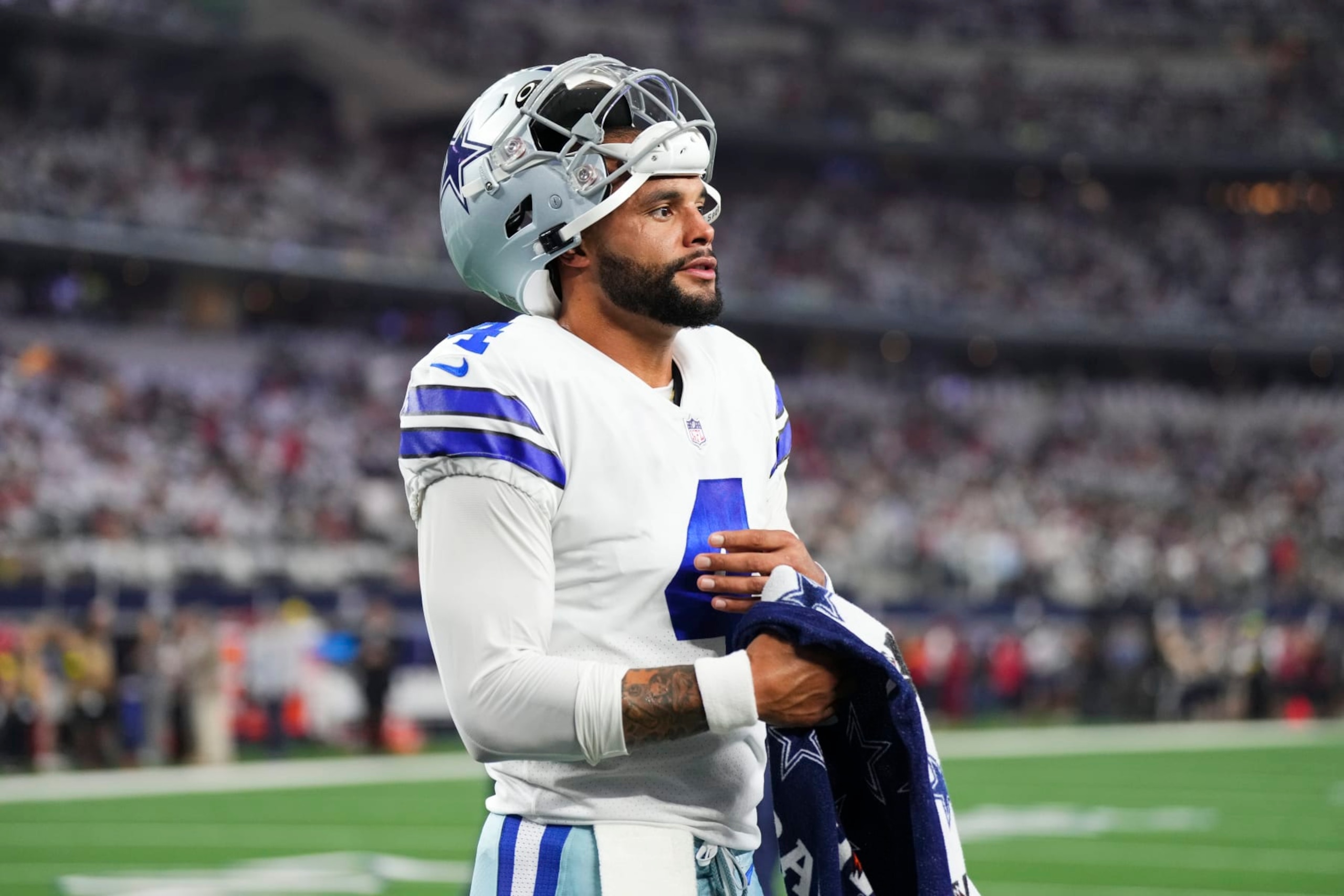 ARLINGTON, TX - SEPTEMBER 11: Dak Prescott #4 of the Dallas Cowboys uses a Gatorade towel to wipe his hand against the Tampa Bay Buccaneers at AT&T Stadium on September 11, 2022 in Arlington, TX. (Photo by Cooper Neill/Getty Images)