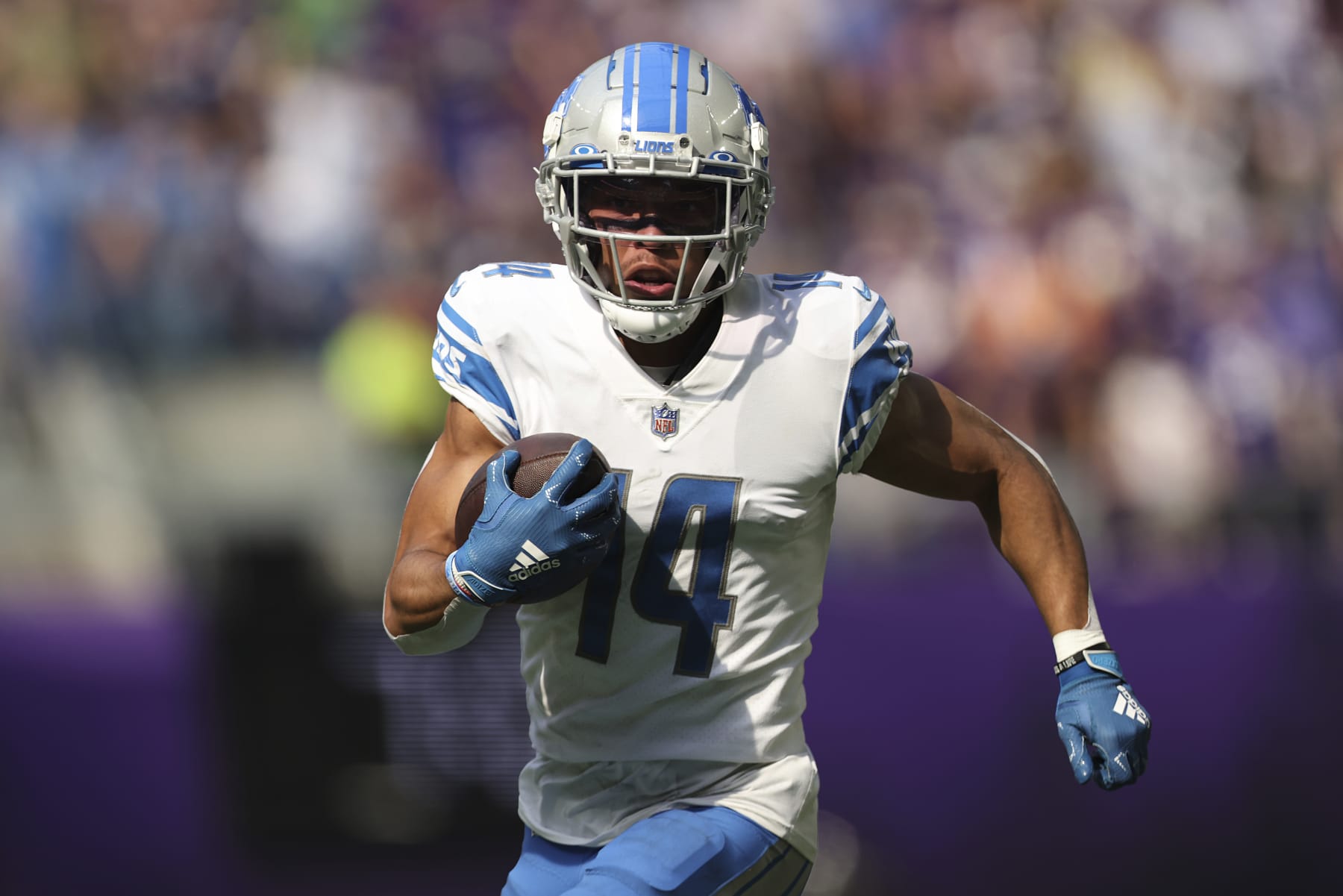 Detroit Lions wide receiver Amon-Ra St. Brown (14) carries the ball during the first half of an NFL football game against the Minnesota Vikings, Sunday, Sept. 25, 2022 in Minneapolis. (AP Photo/Stacy Bengs)