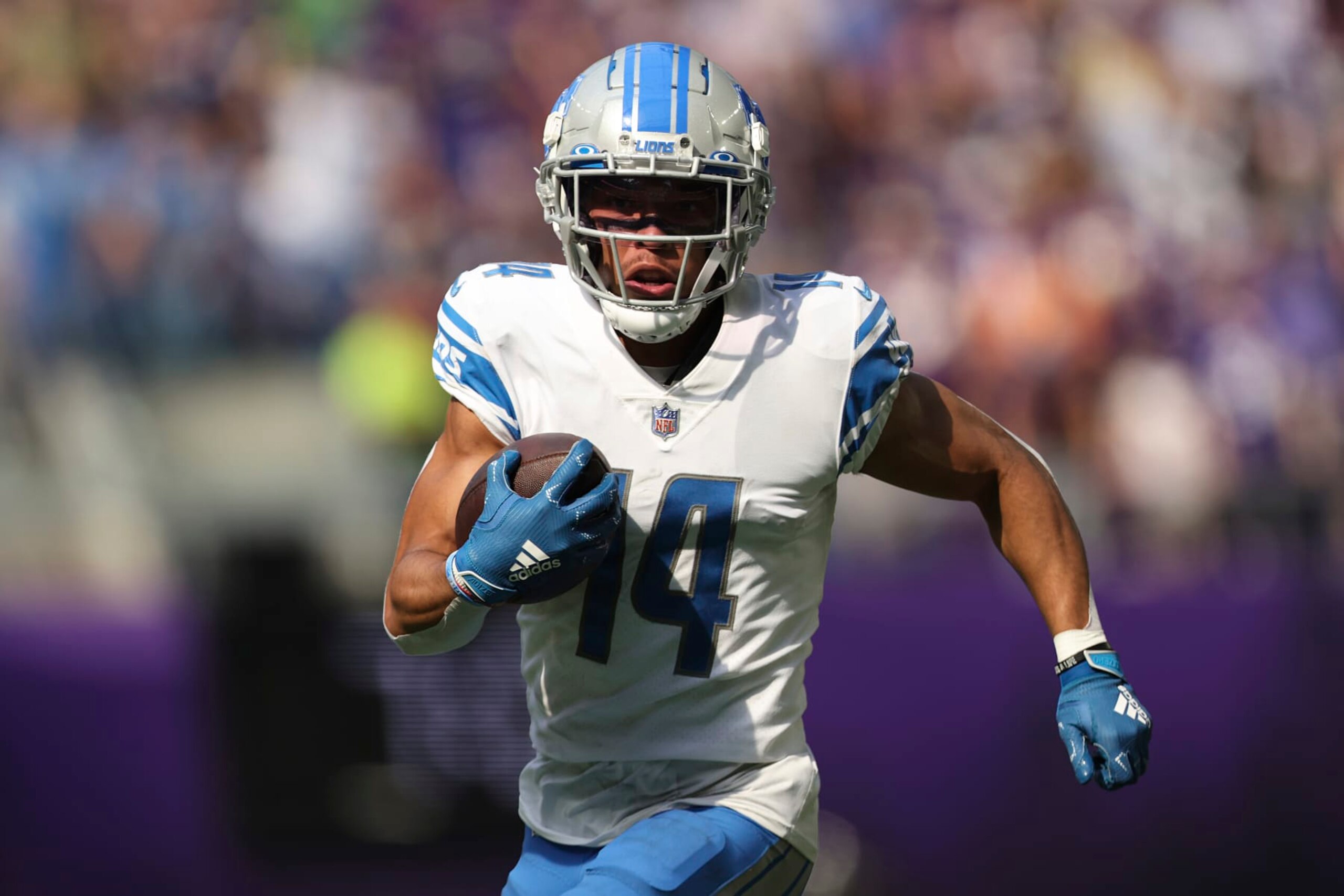 Detroit Lions wide receiver Amon-Ra St. Brown (14) carries the ball during the first half of an NFL football game against the Minnesota Vikings, Sunday, Sept. 25, 2022 in Minneapolis. (AP Photo/Stacy Bengs)