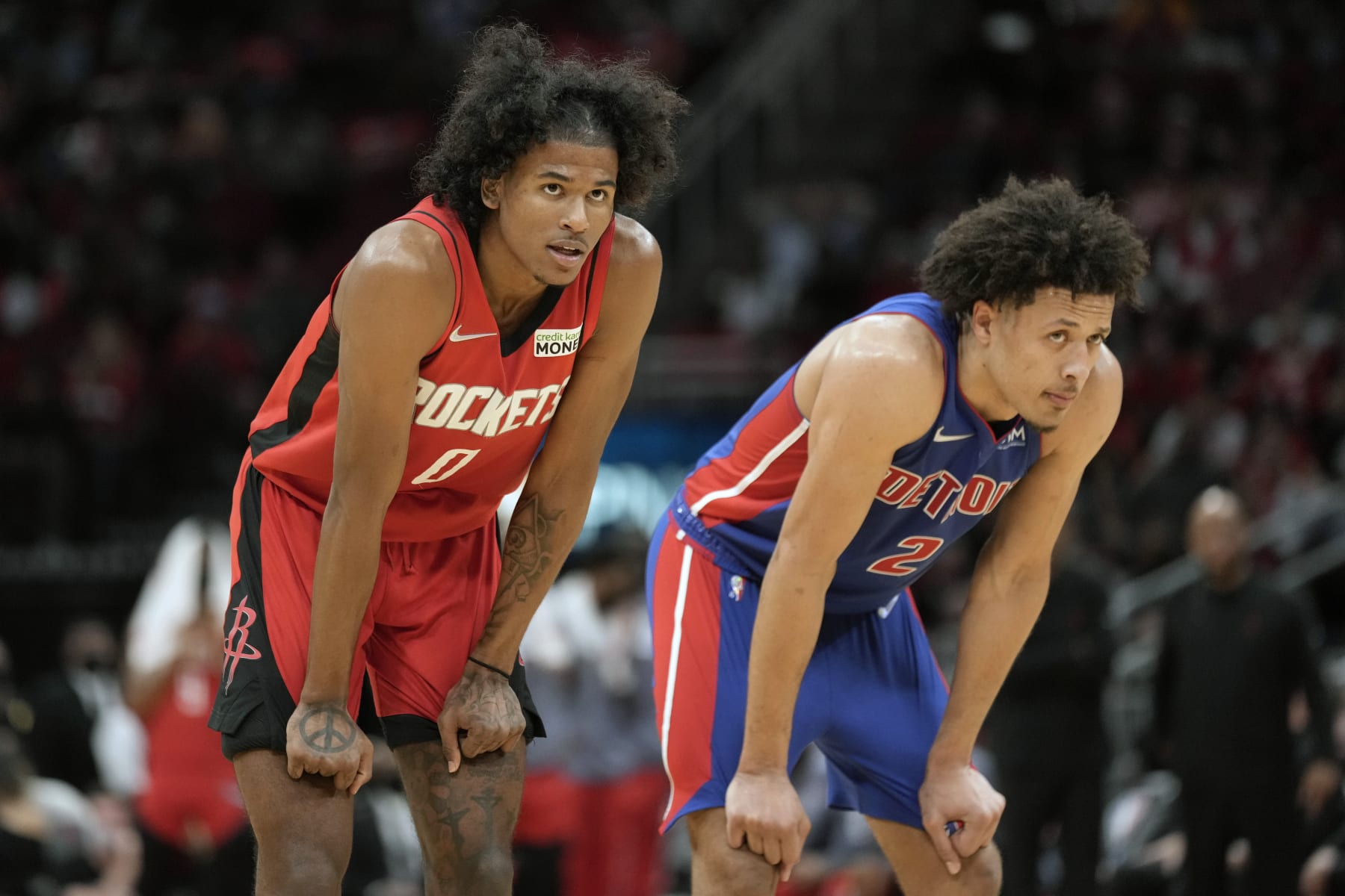 Houston Rockets guard Jalen Green (0) and Detroit Pistons guard Cade Cunningham watch a free throw during the second half of an NBA basketball game, Wednesday, Nov. 10, 2021, in Houston. (AP Photo/Eric Christian Smith)