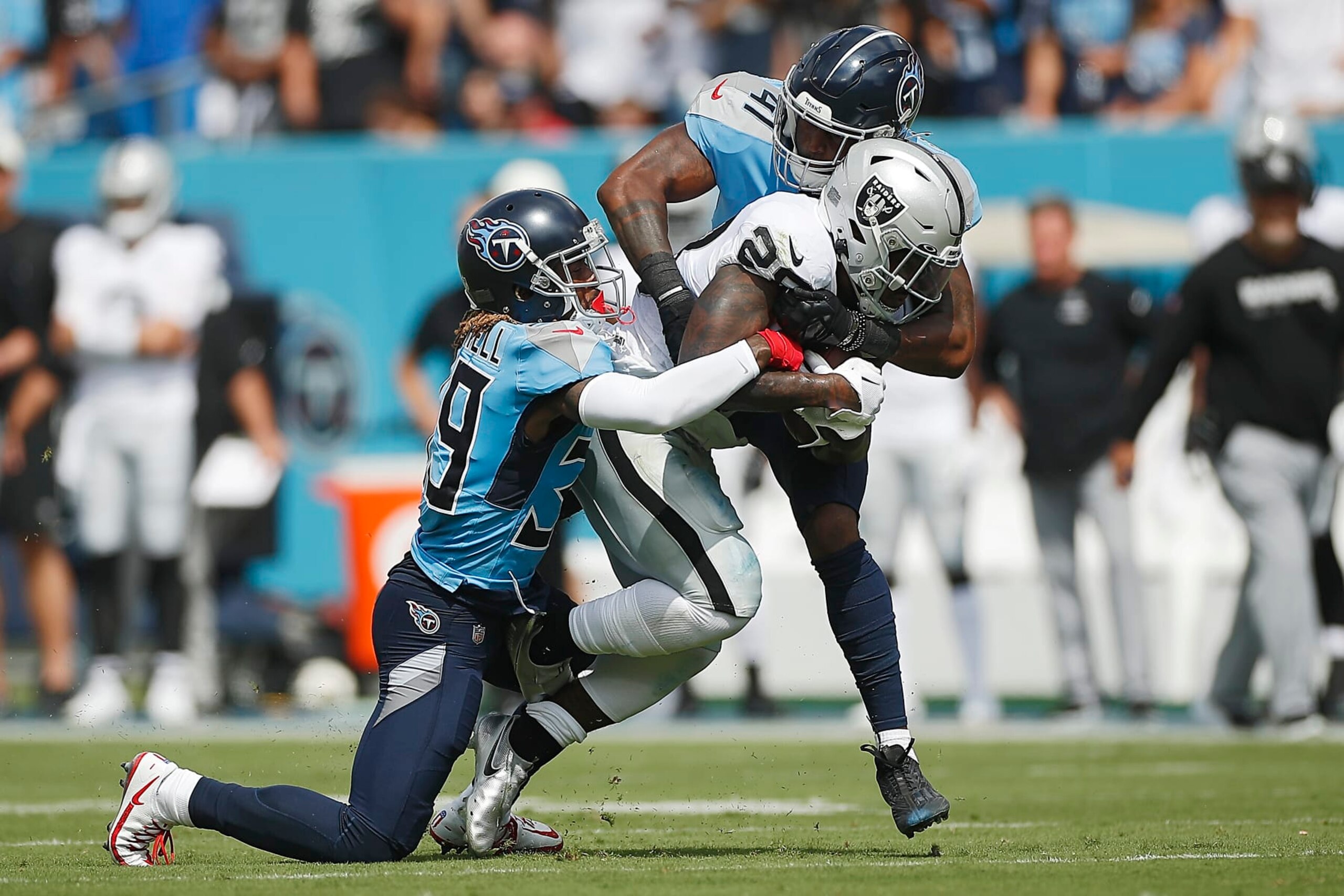 NASHVILLE, TENNESSEE - SEPTEMBER 25: Josh Jacobs #28 of the Las Vegas Raiders is tackled by Terrance Mitchell #39 and Zach Cunningham #41 of the Tennessee Titans during the second quarter at Nissan Stadium on September 25, 2022 in Nashville, Tennessee. (Photo by Silas Walker/Getty Images) NASHVILLE, TENNESSEE - SEPTEMBER 25: Josh Jacobs #28 of the Las Vegas Raiders is tackled by Terrance Mitchell #39 and Zach Cunningham #41 of the Tennessee Titans during the second quarter at Nissan Stadium on September 25, 2022 in Nashville, Tennessee. (Photo by Silas Walker/Getty Images)