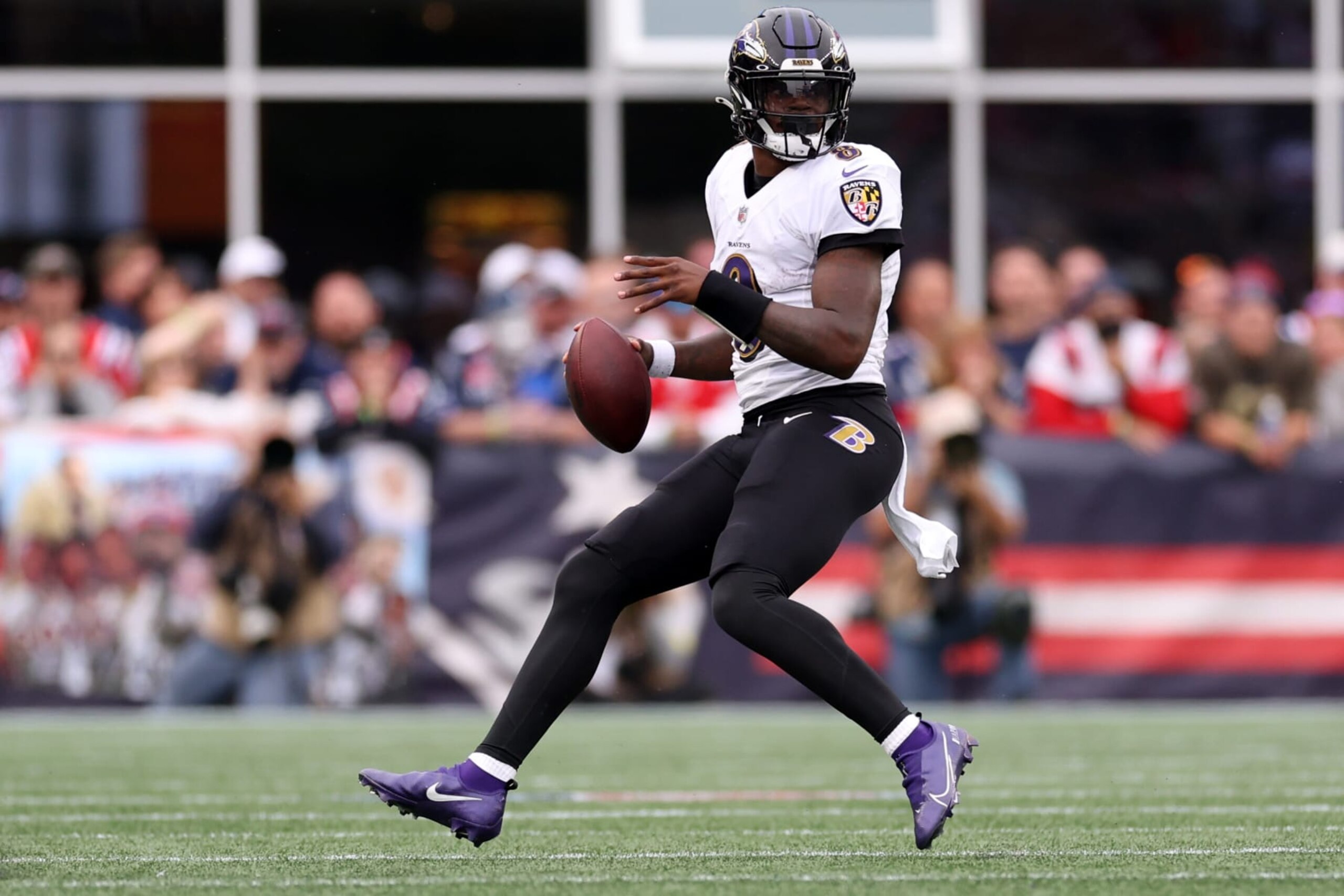FOXBOROUGH, MASSACHUSETTS - SEPTEMBER 25: Lamar Jackson #8 of the Baltimore Ravens carries the ball against the New England Patriots  at Gillette Stadium on September 25, 2022 in Foxborough, Massachusetts. (Photo by Maddie Meyer/Getty Images)