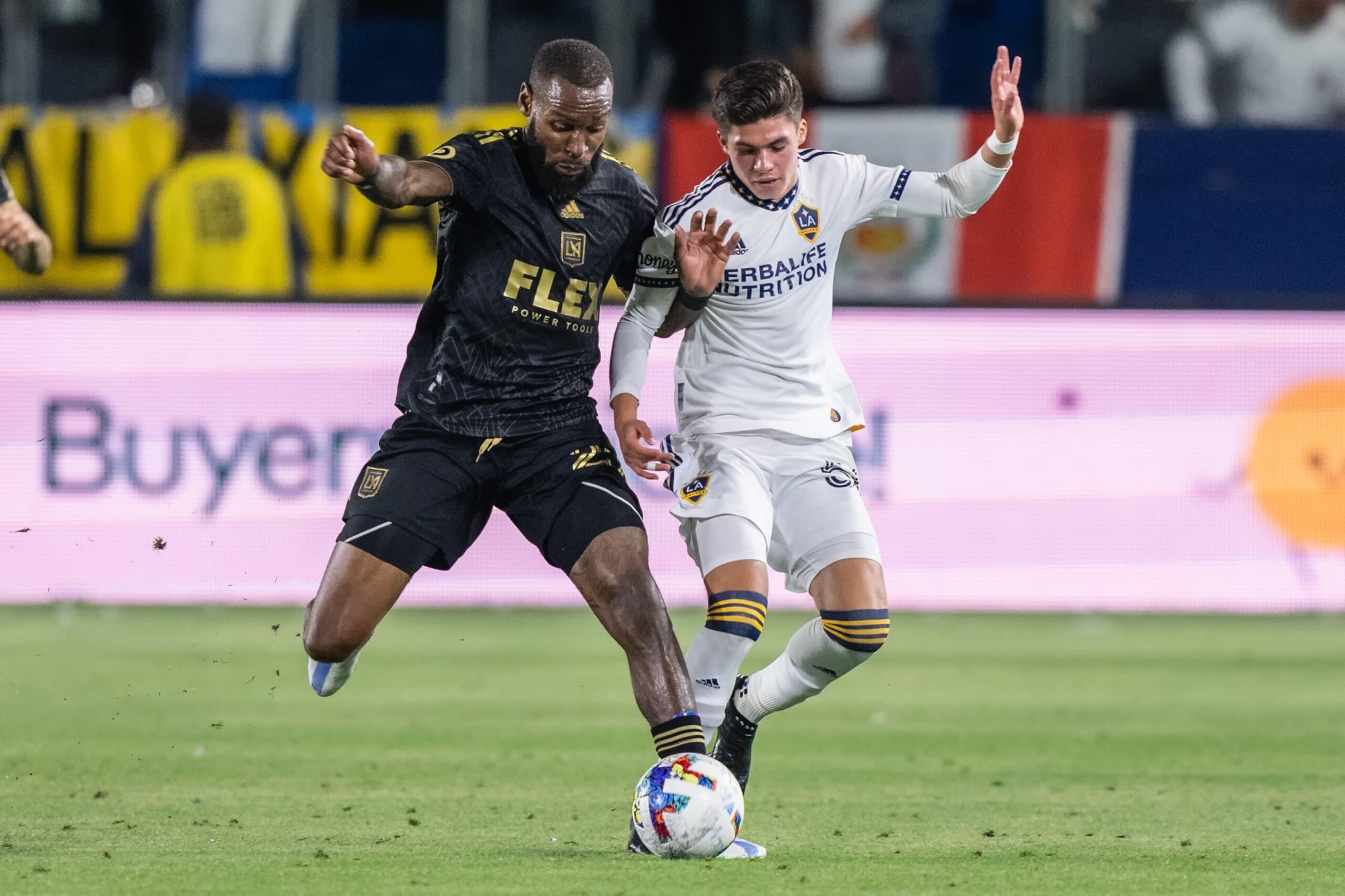 CARSON, CA - MAY 25: Sebastien Ibeagha #25 of Los Angeles FC and Jonathan Pérez #56 of Los Angeles Galaxy during a game between Los Angeles Football Club and LA Galaxy at Dignity Health Sports Park on May 25, 2022 in Carson, California. (Photo by Dave Bernal/ISI Photos/Getty Images)