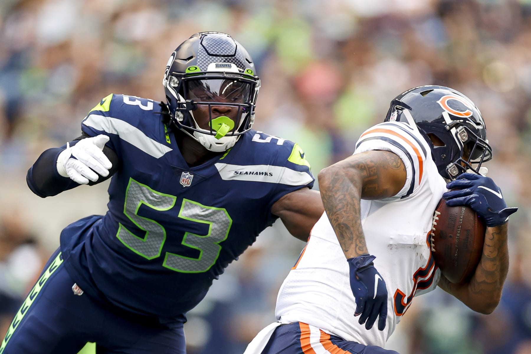 SEATTLE, WASHINGTON - AUGUST 18: Boye Mafe #53 of the Seattle Seahawks looks to tackle Trestan Ebner #31 of the Chicago Bears in the second quarter during the preseason game at Lumen Field on August 18, 2022 in Seattle, Washington. (Photo by Steph Chambers/Getty Images)