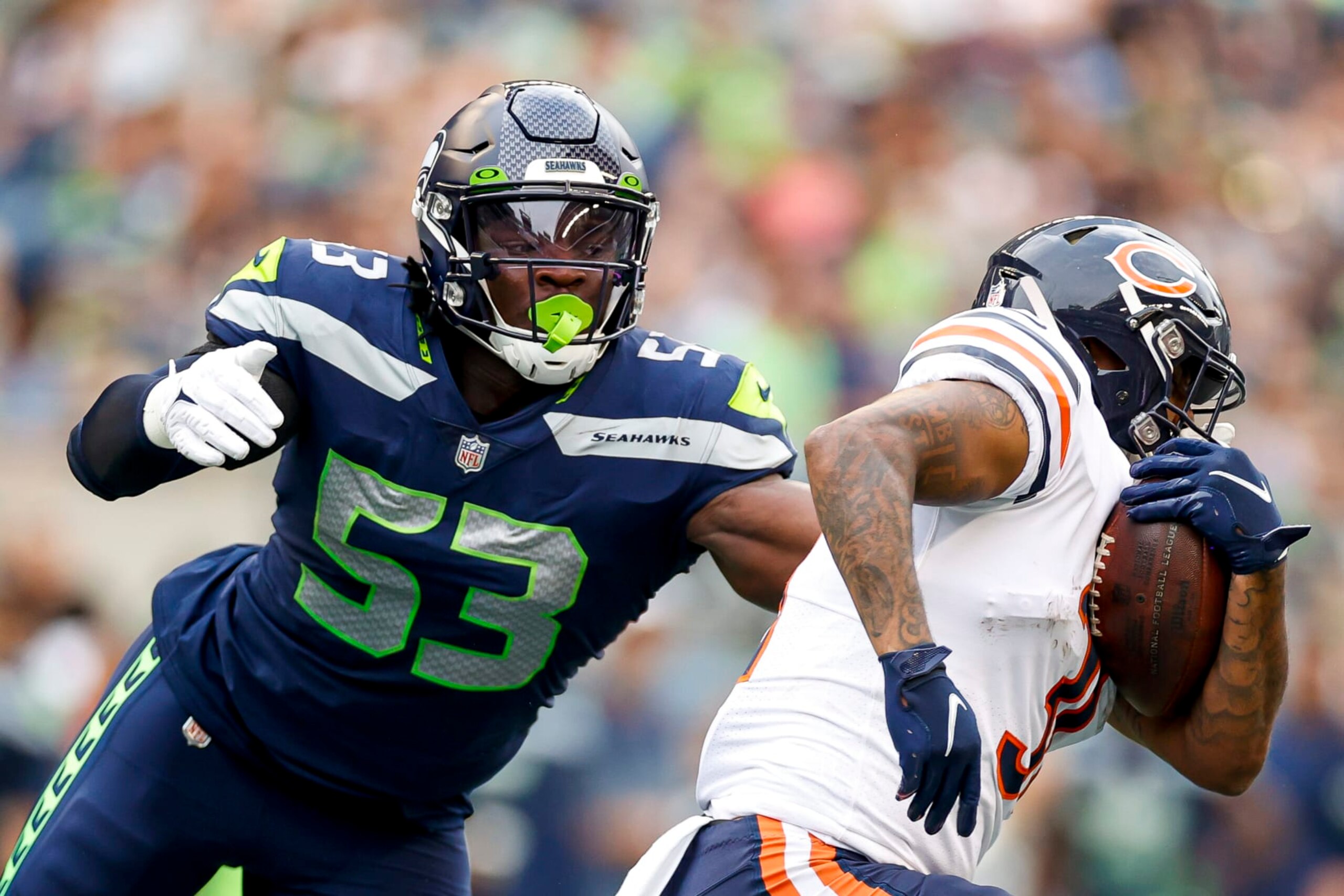 SEATTLE, WASHINGTON - AUGUST 18: Boye Mafe #53 of the Seattle Seahawks looks to tackle Trestan Ebner #31 of the Chicago Bears in the second quarter during the preseason game at Lumen Field on August 18, 2022 in Seattle, Washington. (Photo by Steph Chambers/Getty Images)