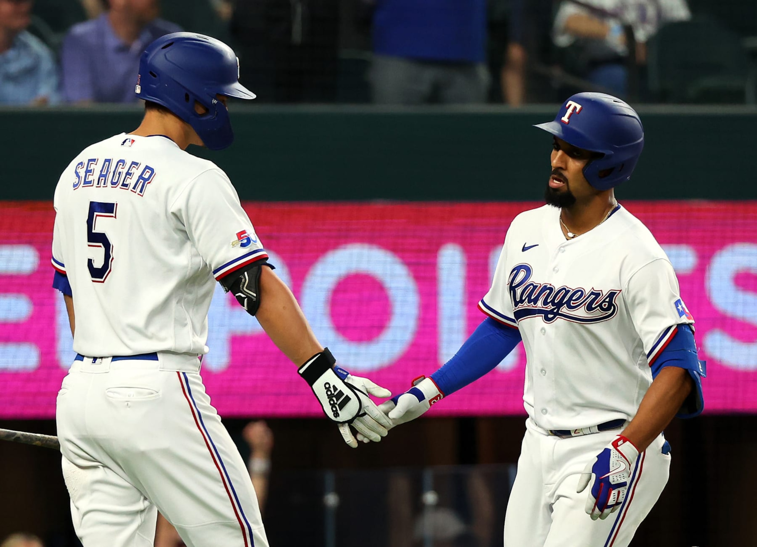 ARLINGTON, TEXAS - SEPTEMBER 24: Corey Seager #5 of the Texas Rangers greets Marcus Semien #2 of the Texas Rangers after a solo home run in the third inning at Globe Life Field on September 24, 2022 in Arlington, Texas. (Photo by Richard Rodriguez/Getty Images) ARLINGTON, TEXAS - SEPTEMBER 24: Corey Seager #5 of the Texas Rangers greets Marcus Semien #2 of the Texas Rangers after a solo home run in the third inning at Globe Life Field on September 24, 2022 in Arlington, Texas. (Photo by Richard Rodriguez/Getty Images)