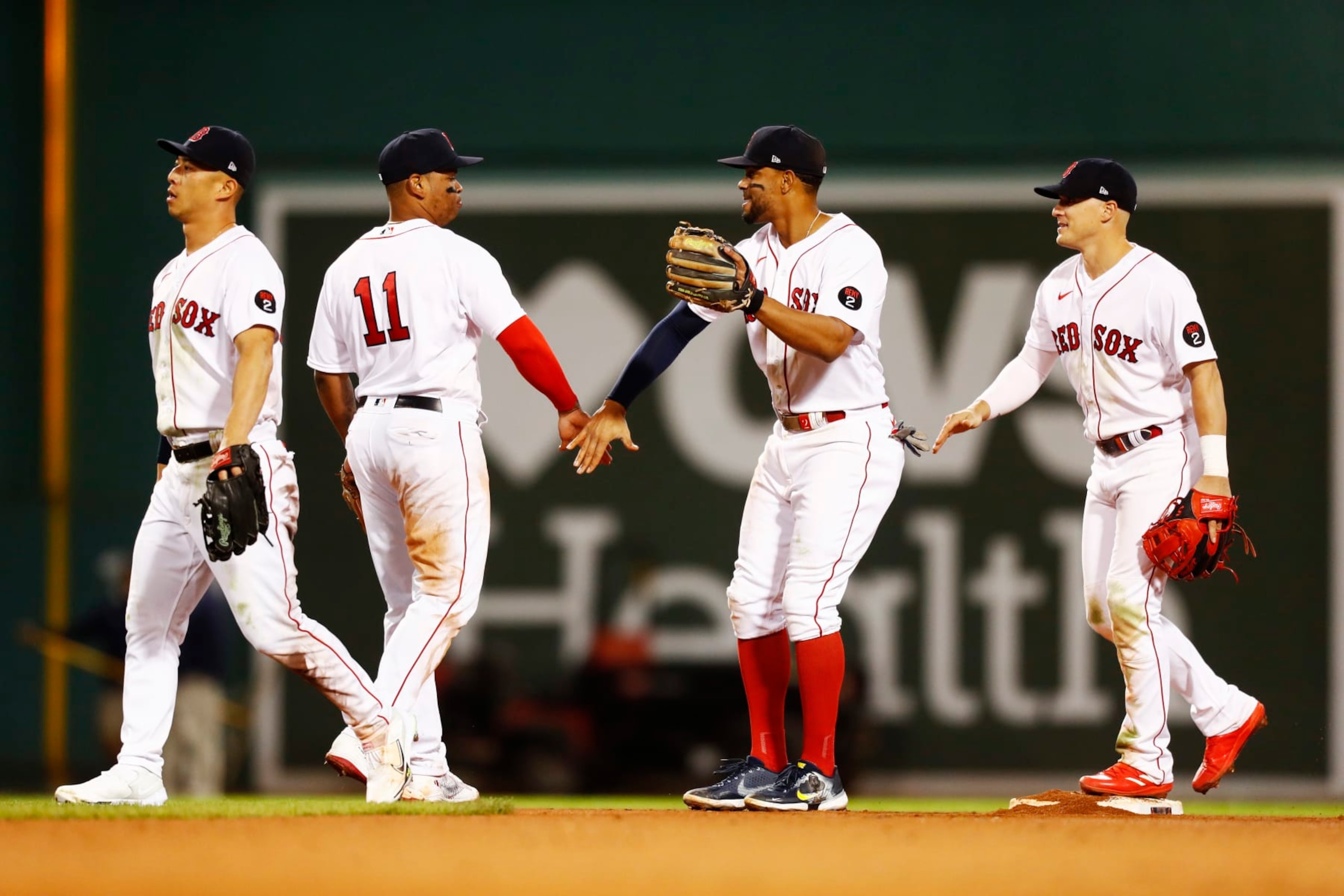 BOSTON, MASSACHUSETTS - SEPTEMBER 27: Xander Bogaerts #2 of the Boston Red Sox celebrates with teammate Rafael Devers #11 after the victory over the Baltimore Orioles at Fenway Park on September 27, 2022 in Boston, Massachusetts. (Photo by Omar Rawlings/Getty Images) BOSTON, MASSACHUSETTS - SEPTEMBER 27: Xander Bogaerts #2 of the Boston Red Sox celebrates with teammate Rafael Devers #11 after the victory over the Baltimore Orioles at Fenway Park on September 27, 2022 in Boston, Massachusetts. (Photo by Omar Rawlings/Getty Images)