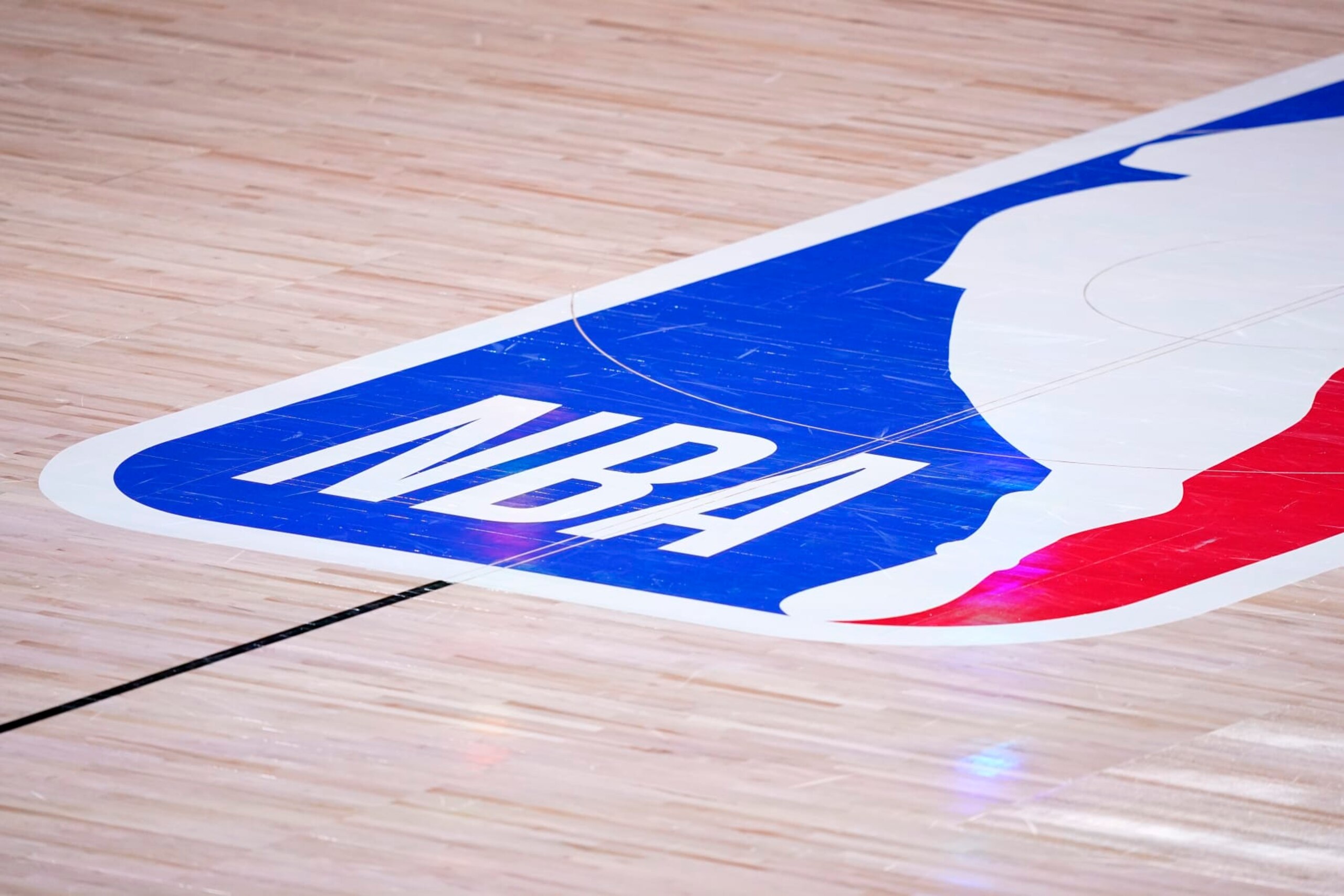 The court floor and league logo are shown after Game 3 of the NBA basketball Western Conference final between the Los Angeles Lakers and Denver Nuggets on Tuesday, Sept. 22, 2020, in Lake Buena Vista, Fla. (AP Photo/Mark J. Terrill) The court floor and league logo are shown after Game 3 of the NBA basketball Western Conference final between the Los Angeles Lakers and Denver Nuggets on Tuesday, Sept. 22, 2020, in Lake Buena Vista, Fla. (AP Photo/Mark J. Terrill)