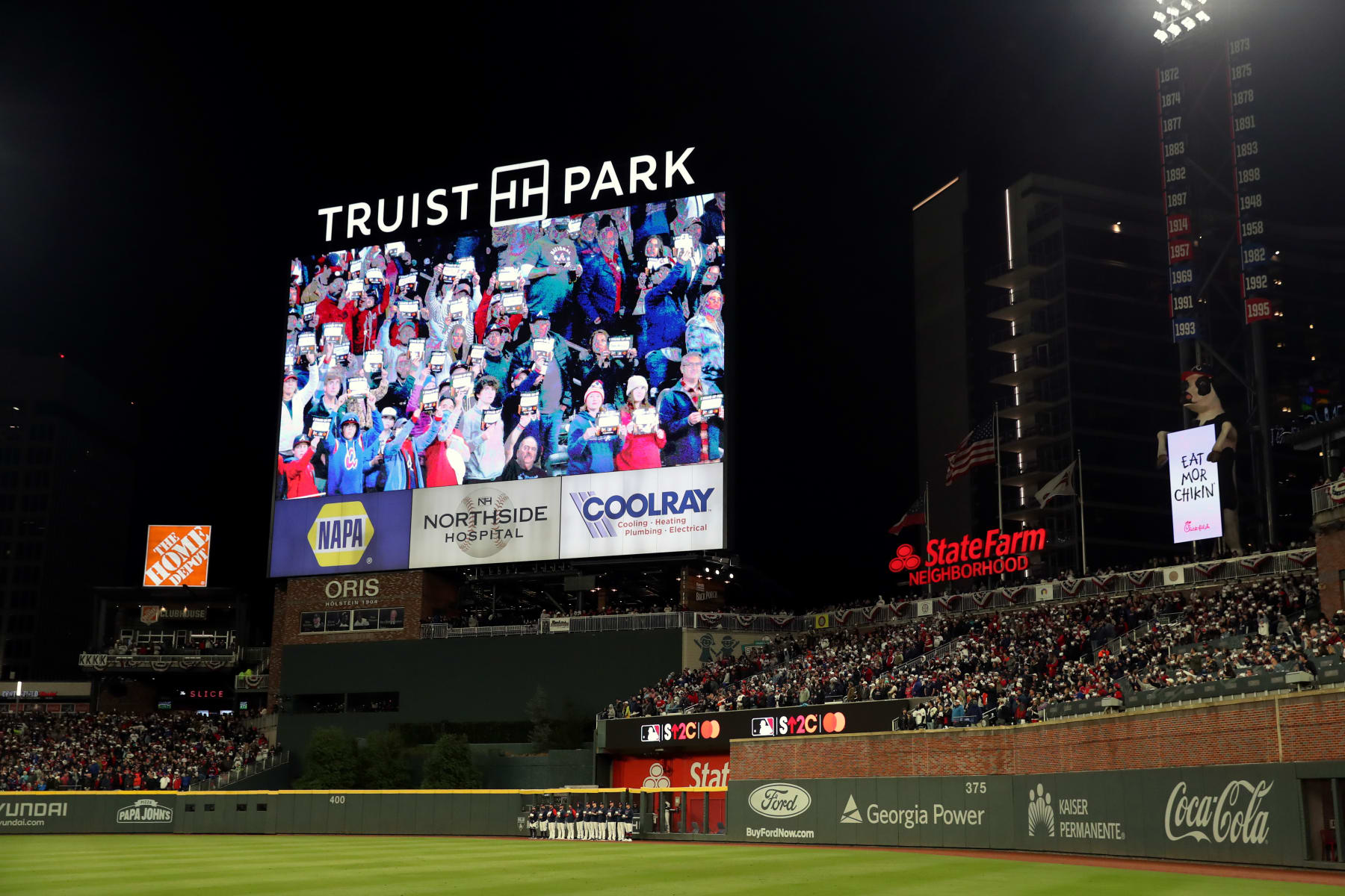 ATLANTA, GA - OCTOBER 30:  A general view of the scoreboard as fans are seen holding up Stand Up 2 Cancer placards during Game 4 of the 2021 World Series between the Houston Astros and the Atlanta Braves at Truist Park on Saturday, October 30, 2021 in Atlanta, Georgia. (Photo by Rob Tringali/MLB Photos via Getty Images)