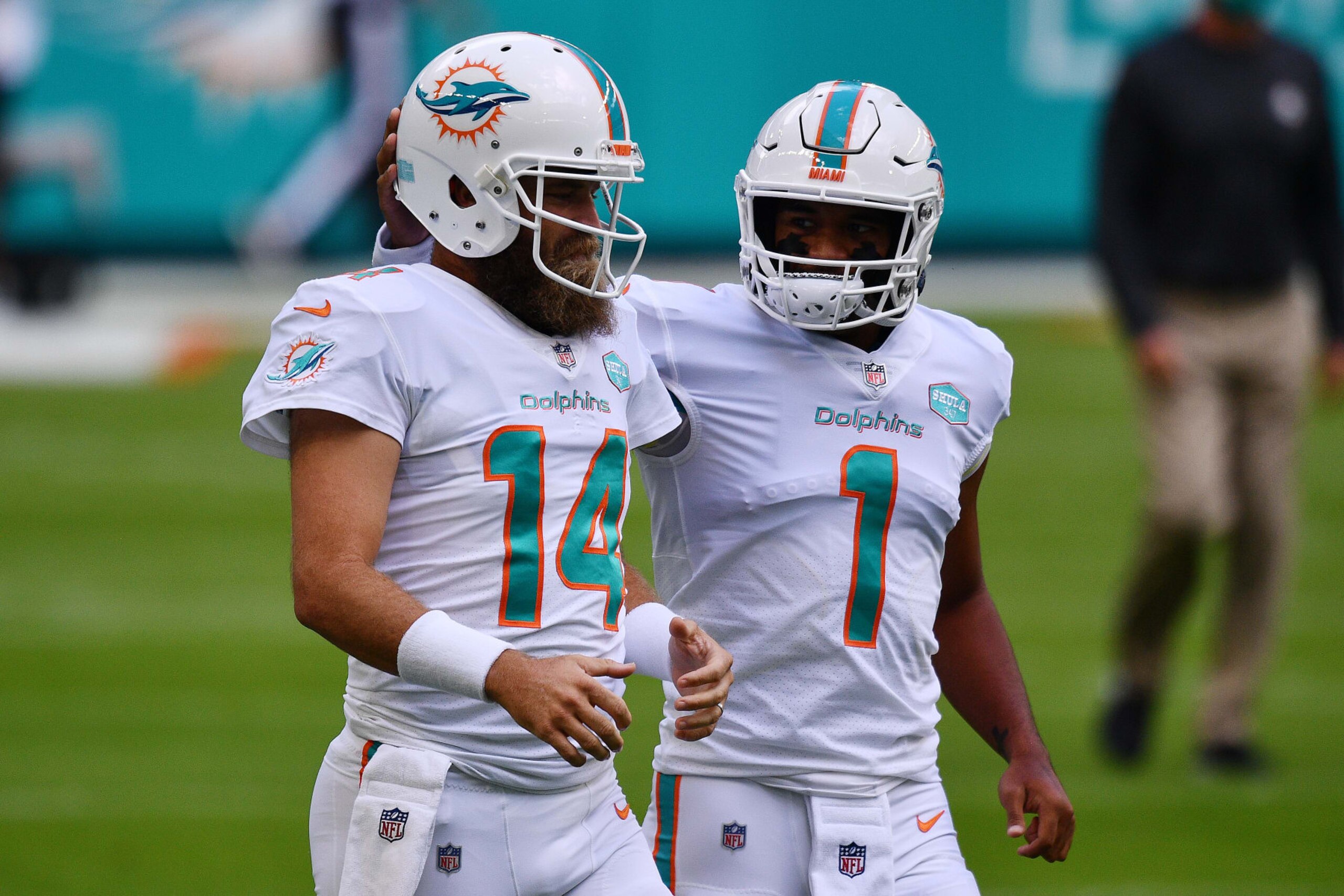 MIAMI GARDENS, FLORIDA - NOVEMBER 01: Tua Tagovailoa #1 and Ryan Fitzpatrick #14 of the Miami Dolphins warm up prior to their game against the Los Angeles Rams at Hard Rock Stadium on November 01, 2020 in Miami Gardens, Florida. (Photo by Mark Brown/Getty Images)