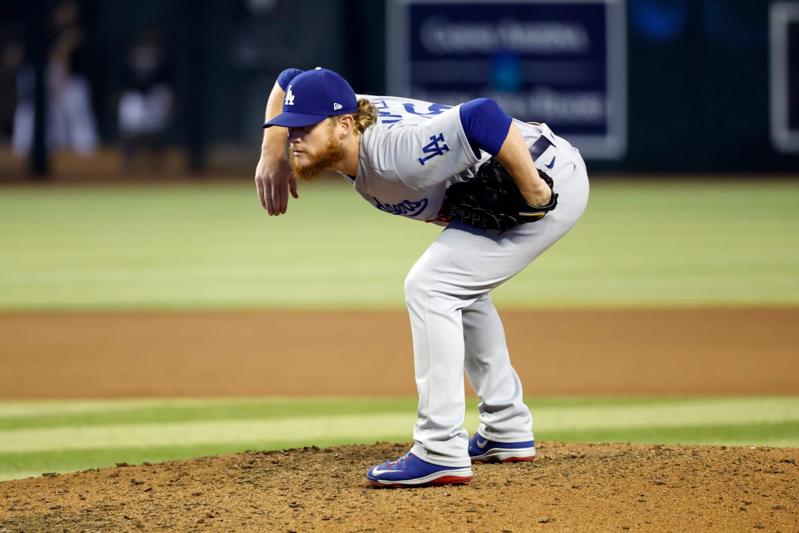 PHOENIX, ARIZONA - SEPTEMBER 14:  Pitcher Craig Kimbrel #46 of the Los Angeles Dodgers takes the sign in the 10th inning against the Arizona Diamondbacks at Chase Field on September 14, 2022 in Phoenix, Arizona. (Photo by Chris Coduto/Getty Images)