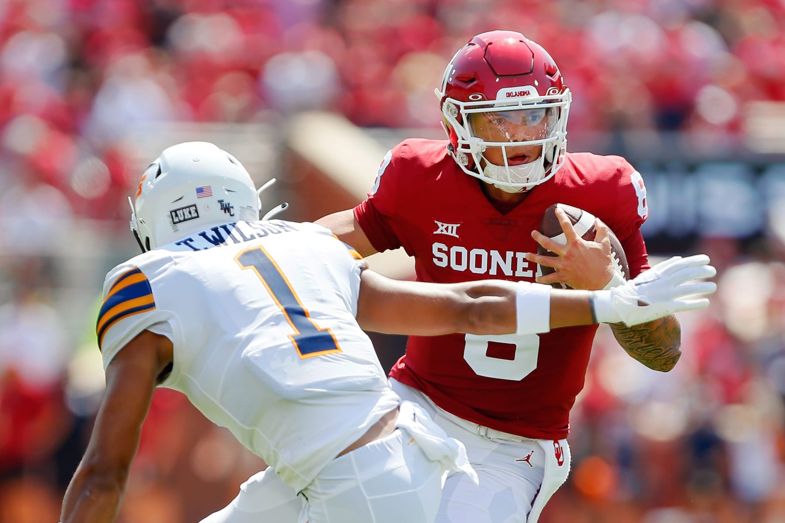 NORMAN, OK - SEPTEMBER 3:  Quarterback Dillon Gabriel #8 of the Oklahoma Sooners sidesteps safety Tyson Wilson #1 of the UTEP Miners for a 12-yard touchdown in the first quarter at Gaylord Family Oklahoma Memorial Stadium on September 3, 2022 in Norman, Oklahoma.  Oklahoma won 45-13.  (Photo by Brian Bahr/Getty Images)