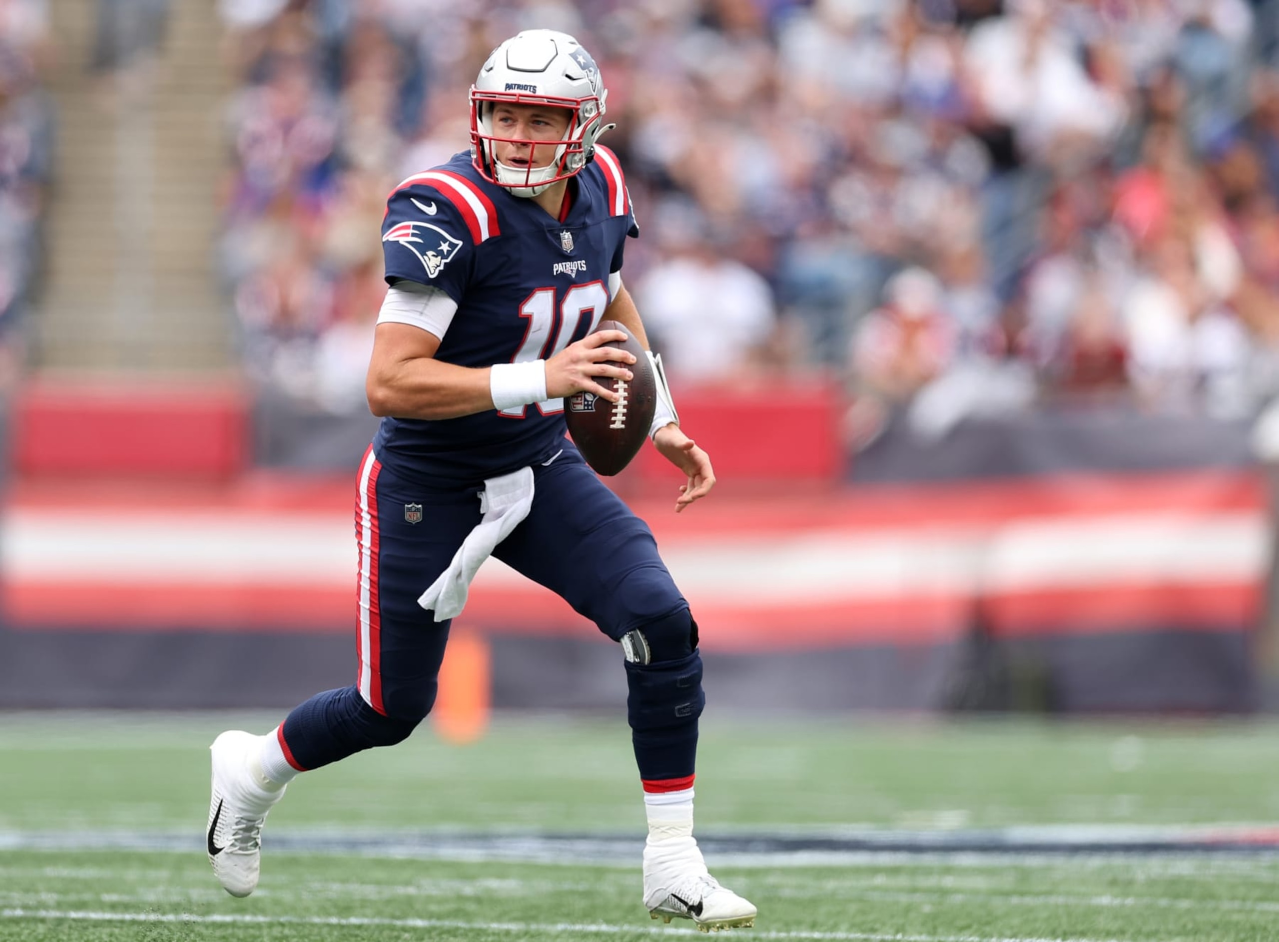 FOXBOROUGH, MASSACHUSETTS - SEPTEMBER 25: Mac Jones #10 of the New England Patriots rushes against the Baltimore Ravens  at Gillette Stadium on September 25, 2022 in Foxborough, Massachusetts. (Photo by Maddie Meyer/Getty Images)