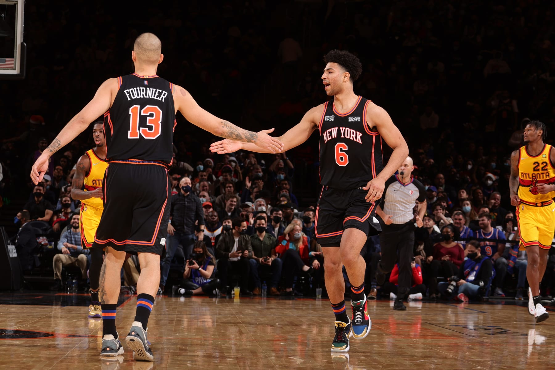 NEW YORK, NY - DECEMBER 25: Quentin Grimes #6 hi-fives Evan Fournier #13 of the New York Knicks during the game against the Atlanta Hawks on December 25, 2021 at Madison Square Garden in New York City, New York.  NOTE TO USER: User expressly acknowledges and agrees that, by downloading and or using this photograph, User is consenting to the terms and conditions of the Getty Images License Agreement. Mandatory Copyright Notice: Copyright 2021 NBAE  (Photo by Nathaniel S. Butler/NBAE via Getty Images)