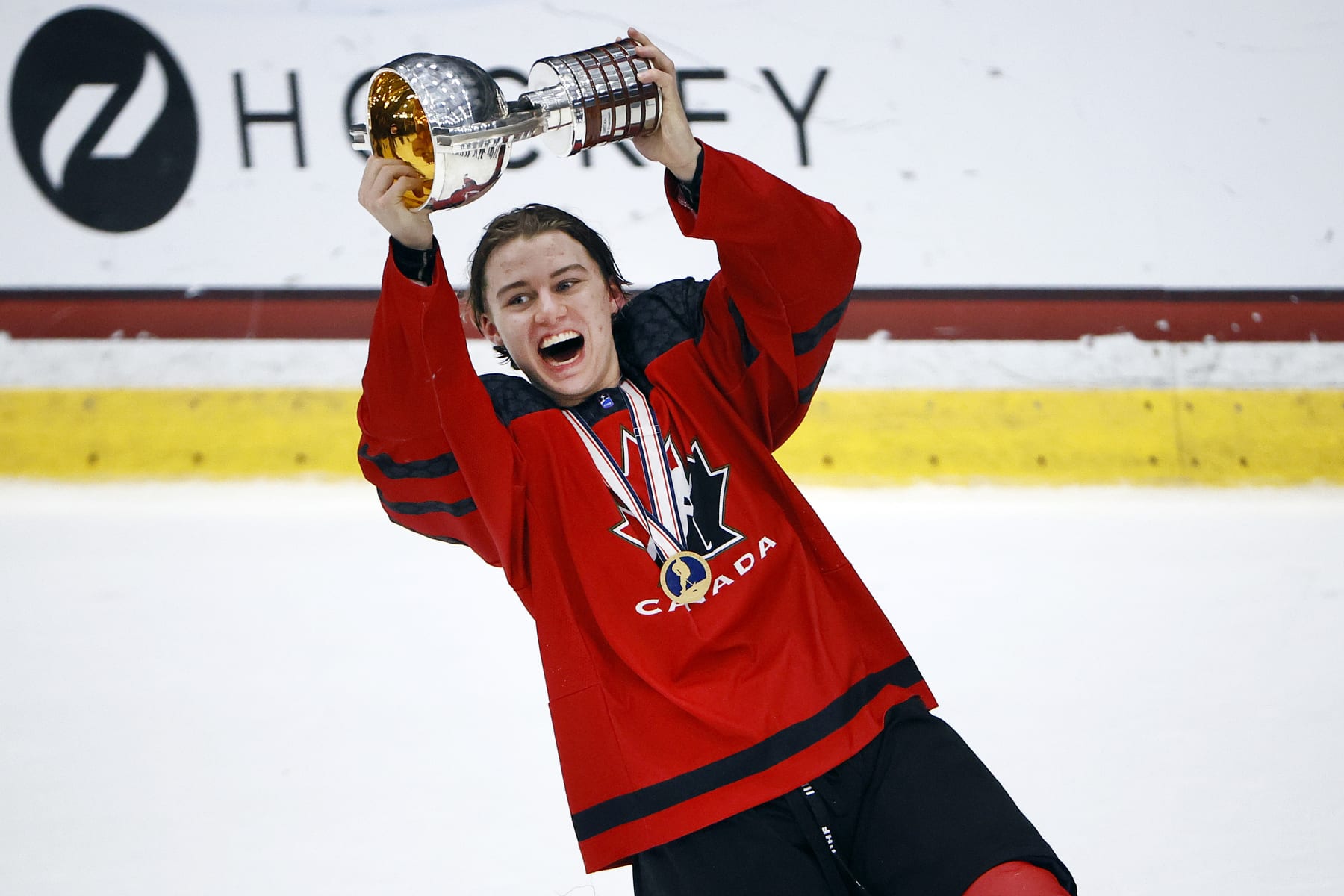 FRISCO, TEXAS - MAY 06: Connor Bedard #17 of Canada celebrates with the championship trophy after defeating Russia 5-3 in the 2021 IIHF Ice Hockey U18 World Championship Gold Medal Game at Comerica Center on May 06, 2021 in Frisco, Texas. (Photo by Tom Pennington/Getty Images)