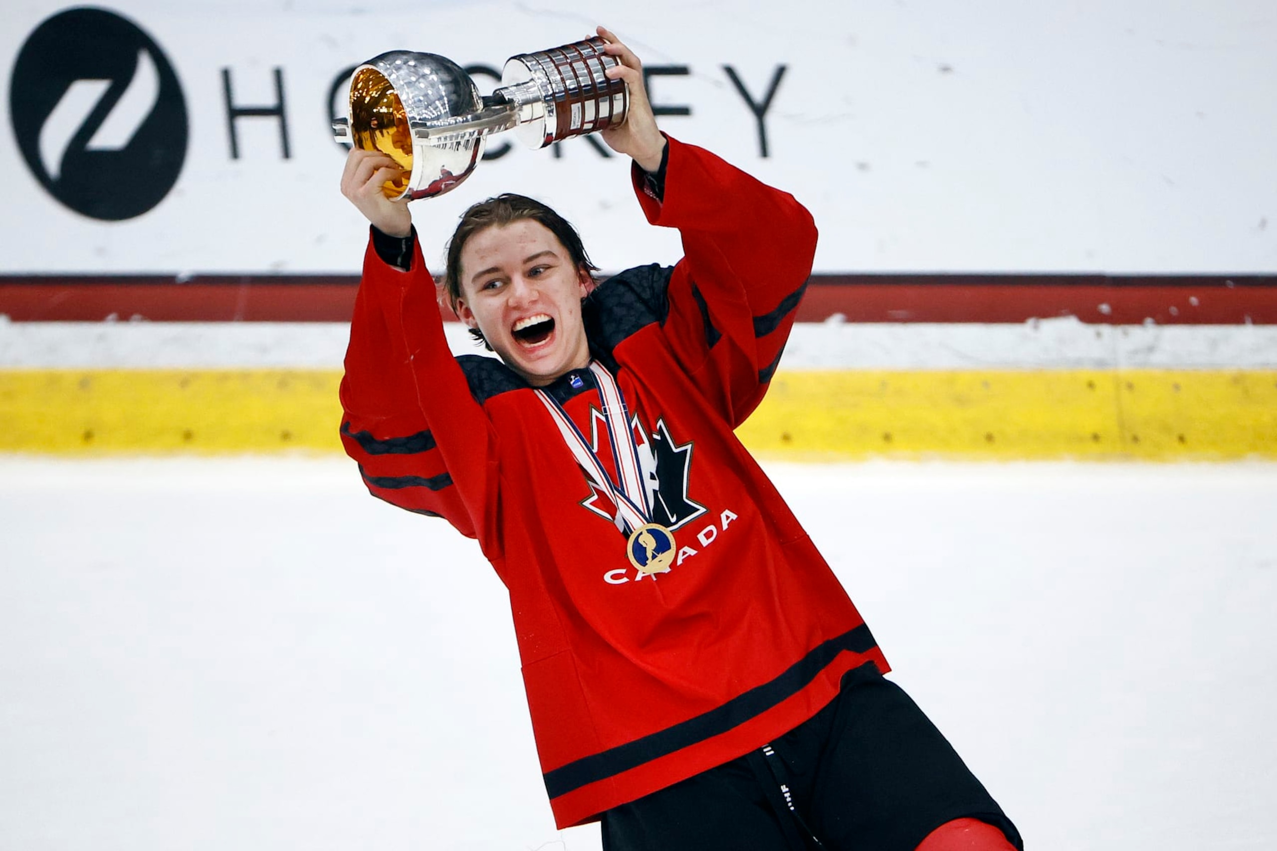 FRISCO, TEXAS - MAY 06: Connor Bedard #17 of Canada celebrates with the championship trophy after defeating Russia 5-3 in the 2021 IIHF Ice Hockey U18 World Championship Gold Medal Game at Comerica Center on May 06, 2021 in Frisco, Texas. (Photo by Tom Pennington/Getty Images)