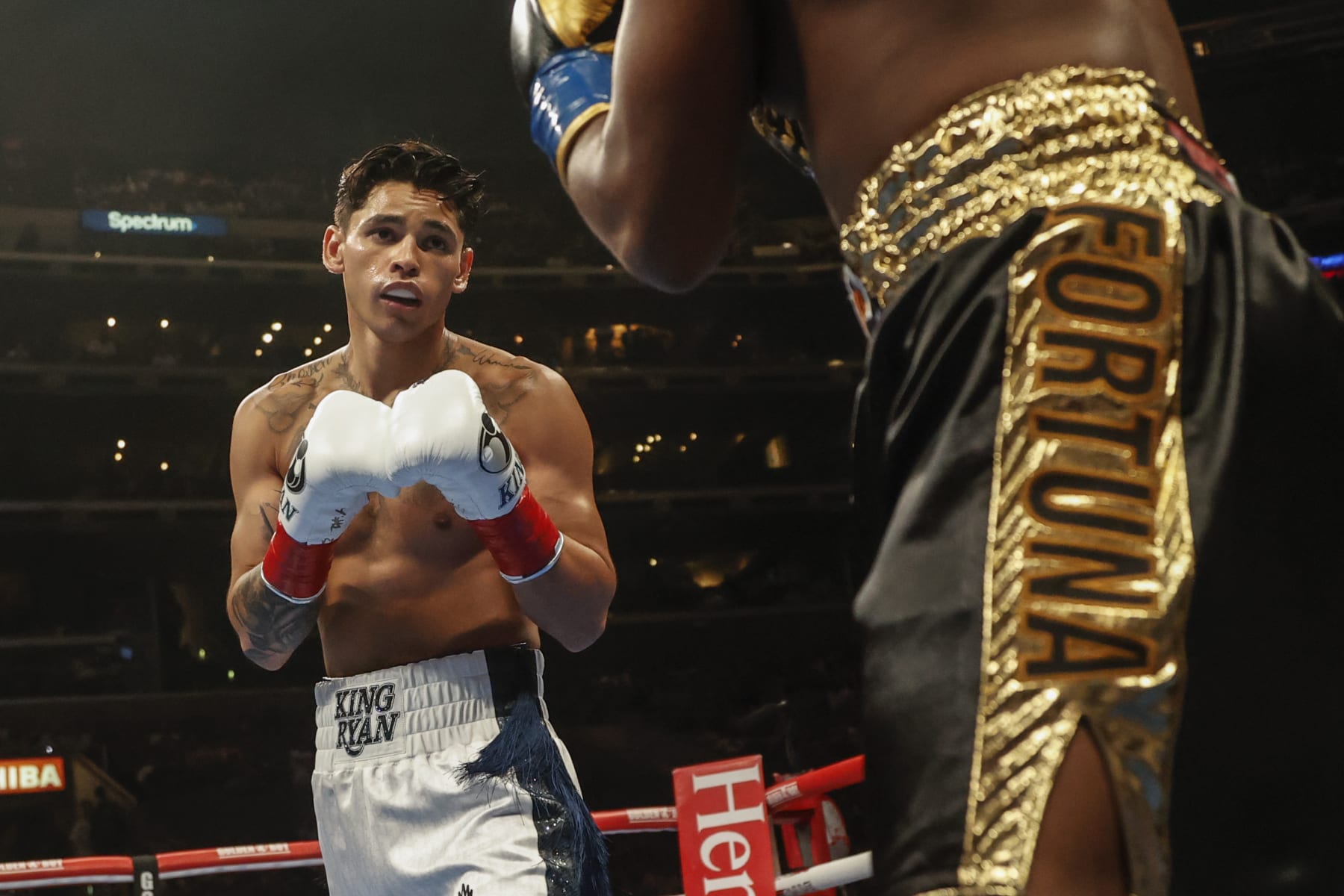 Ryan Garcia, left, and Javier Fortuna exchange punches during a lightweight boxing match Saturday, July 16, 2022, in Los Angeles. (AP Photo/Ringo H.W. Chiu)