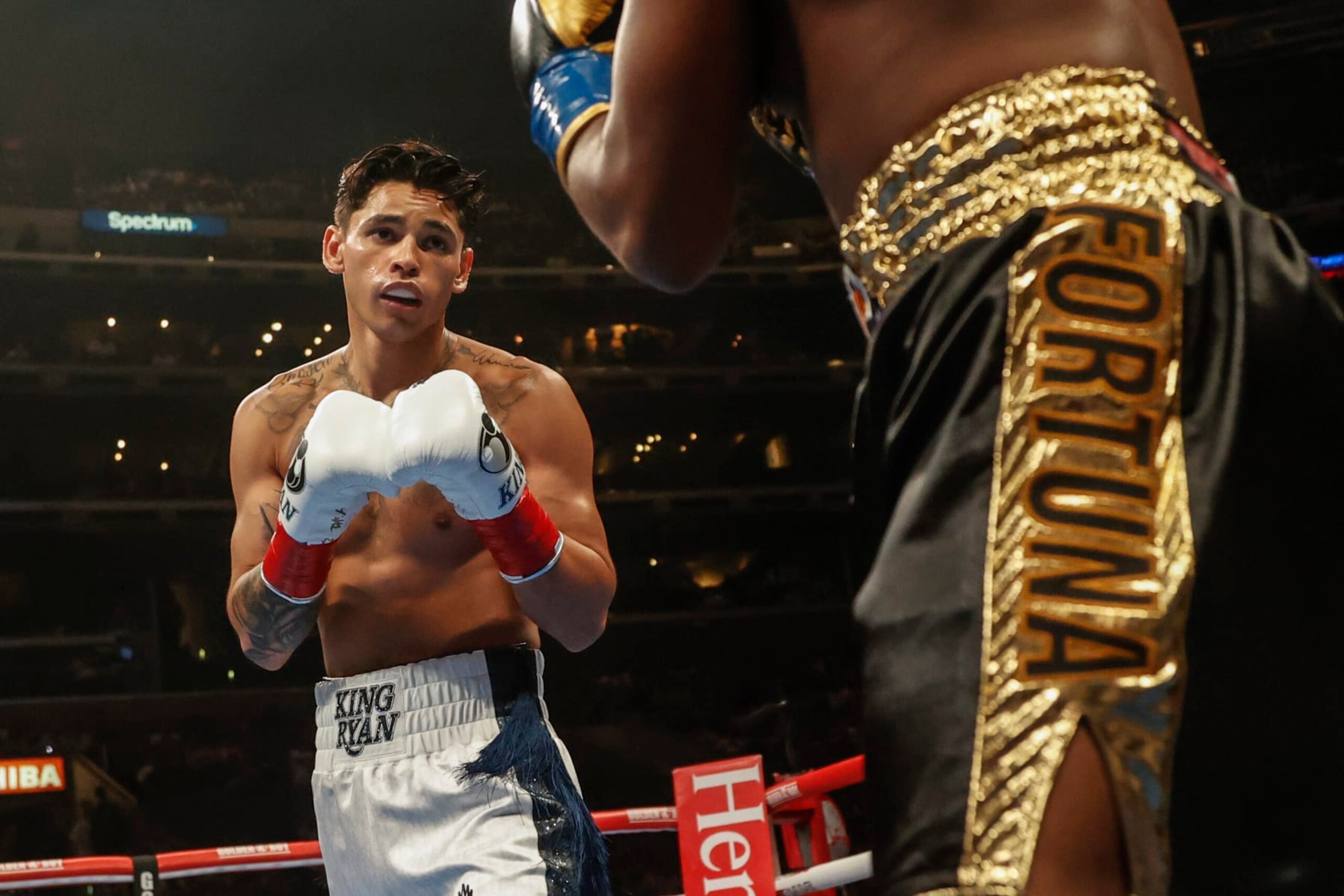 Ryan Garcia, left, and Javier Fortuna exchange punches during a lightweight boxing match Saturday, July 16, 2022, in Los Angeles. (AP Photo/Ringo H.W. Chiu)