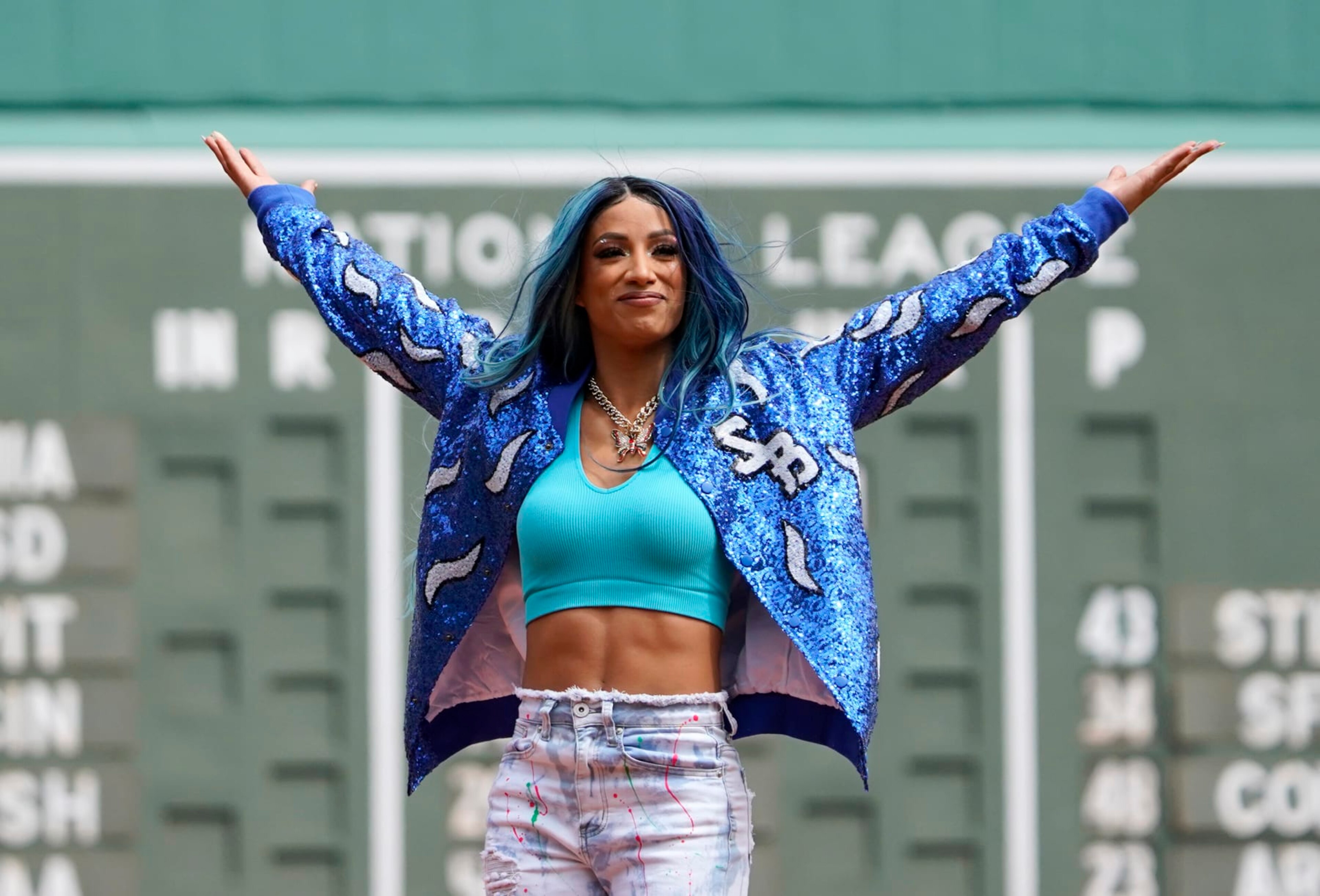 WWE wrestler Sasha Banks reacts before throwing out the first pitch before the start of baseball game between the Boston Red Sox and the Chicago White Sox at Fenway Park, Sunday, May 8, 2022, in Boston. (AP Photo/Mary Schwalm) WWE wrestler Sasha Banks reacts before throwing out the first pitch before the start of baseball game between the Boston Red Sox and the Chicago White Sox at Fenway Park, Sunday, May 8, 2022, in Boston. (AP Photo/Mary Schwalm)