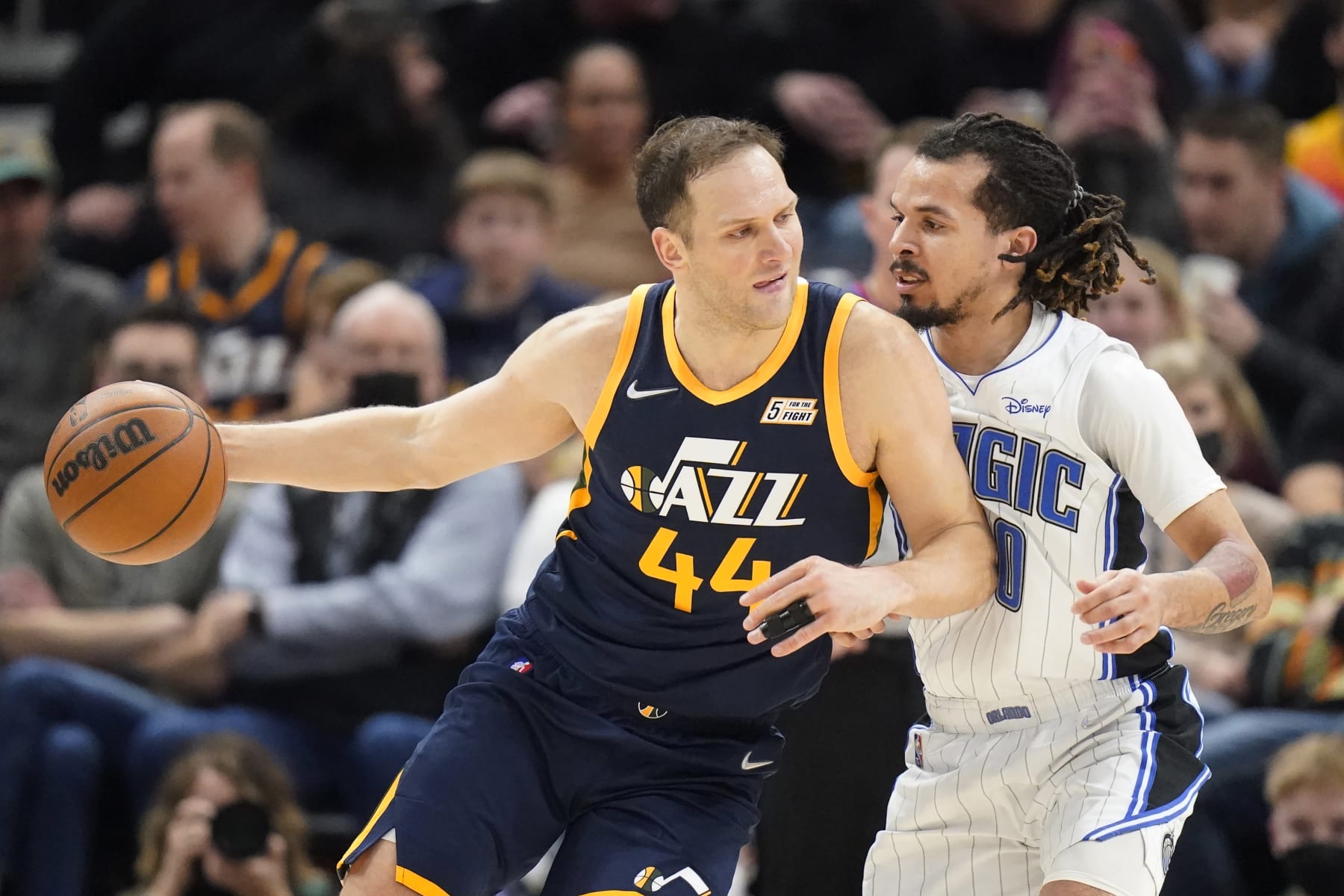 Orlando Magic guard Cole Anthony, right, guards Utah Jazz forward Bojan Bogdanovic (44) in the first half during an NBA basketball game Friday, Feb. 11, 2022, in Salt Lake City. (AP Photo/Rick Bowmer)