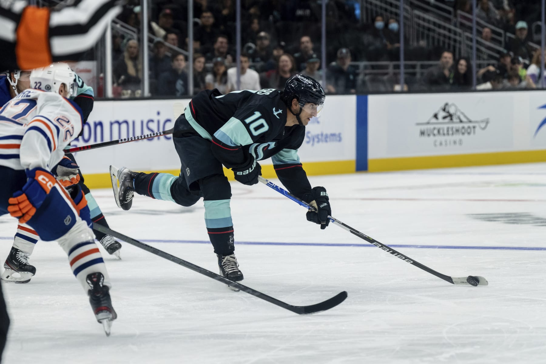Seattle Kraken forward Matty Beniers skates against defenseman Tyson Barrie during the third period of a preseason NHL hockey game, Monday, Sept. 26, 2022, in Seattle. The Kraken won 3-0. (AP Photo/Stephen Brashear)