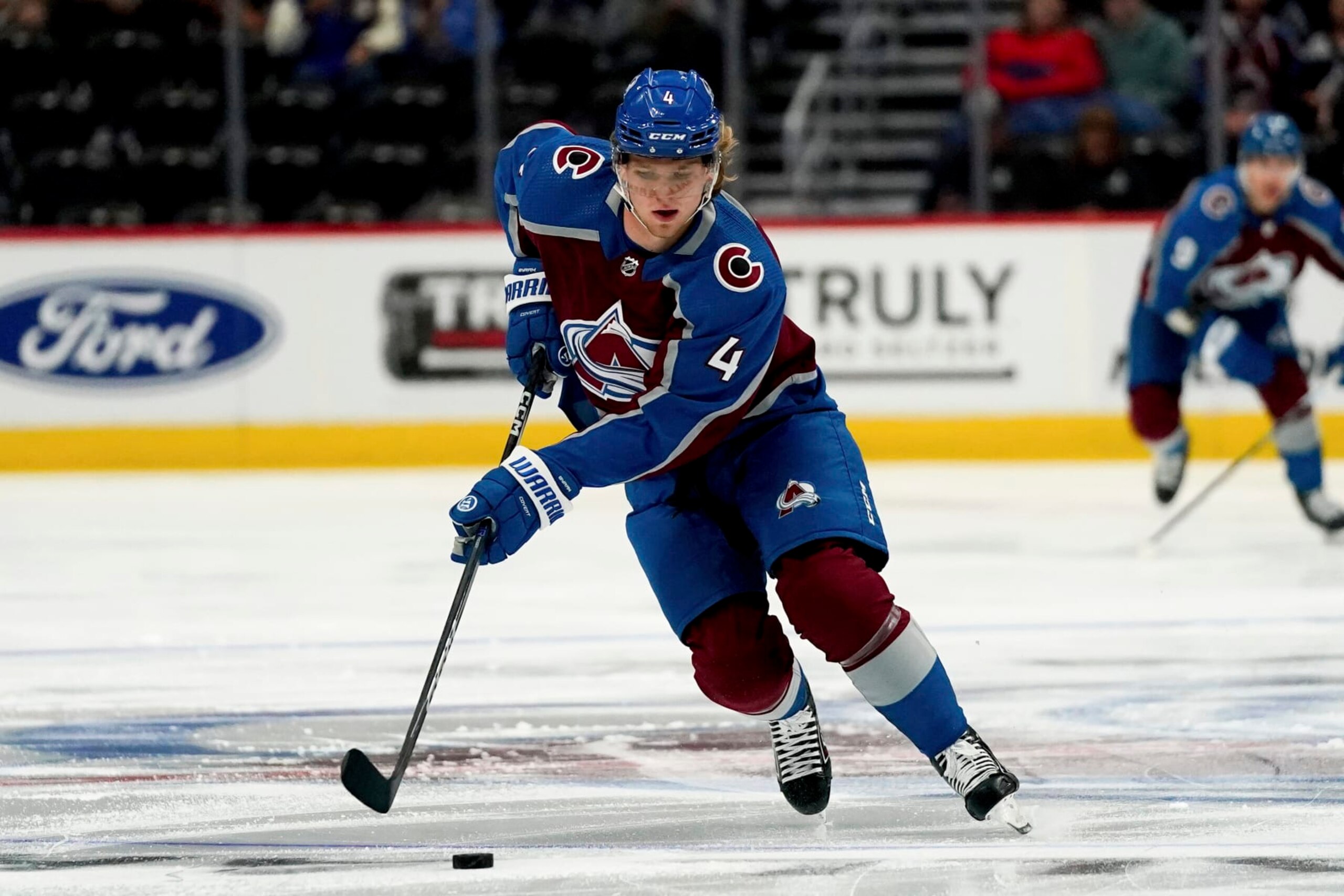 Colorado Avalanche defenseman Bowen Byram skates against the Vegas Golden Knights in the first period of an NHL preseason hockey game Sunday, Sept. 25, 2022, in Denver. (AP Photo/Geneva Heffernan)