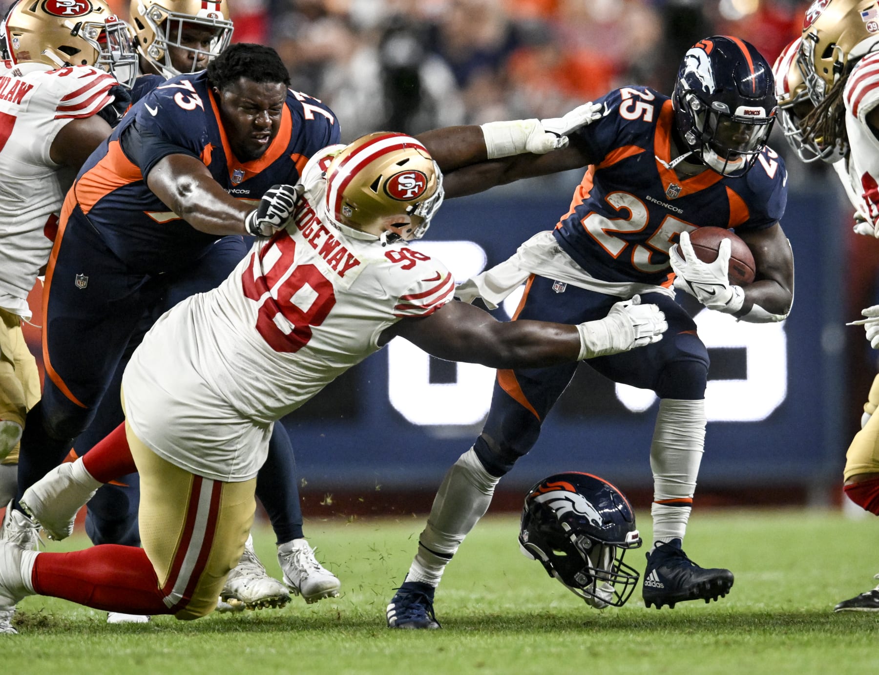 DENVER, CO - SEPTEMBER 25: Melvin Gordon III (25) of the Denver Broncos runs as Cameron Fleming (73) blocks Hassan Ridgeway (98) of the San Francisco 49ers while losing his lid during the third quarter at Empower Field at Mile High on Sunday, September 25, 2022. (Photo by AAron Ontiveroz/MediaNews Group/The Denver Post via Getty Images)
