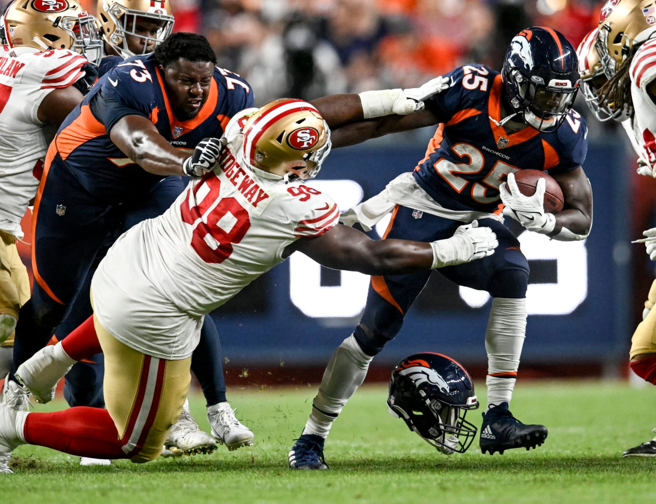 DENVER, CO - SEPTEMBER 25: Melvin Gordon III (25) of the Denver Broncos runs as Cameron Fleming (73) blocks Hassan Ridgeway (98) of the San Francisco 49ers while losing his lid during the third quarter at Empower Field at Mile High on Sunday, September 25, 2022. (Photo by AAron Ontiveroz/MediaNews Group/The Denver Post via Getty Images)