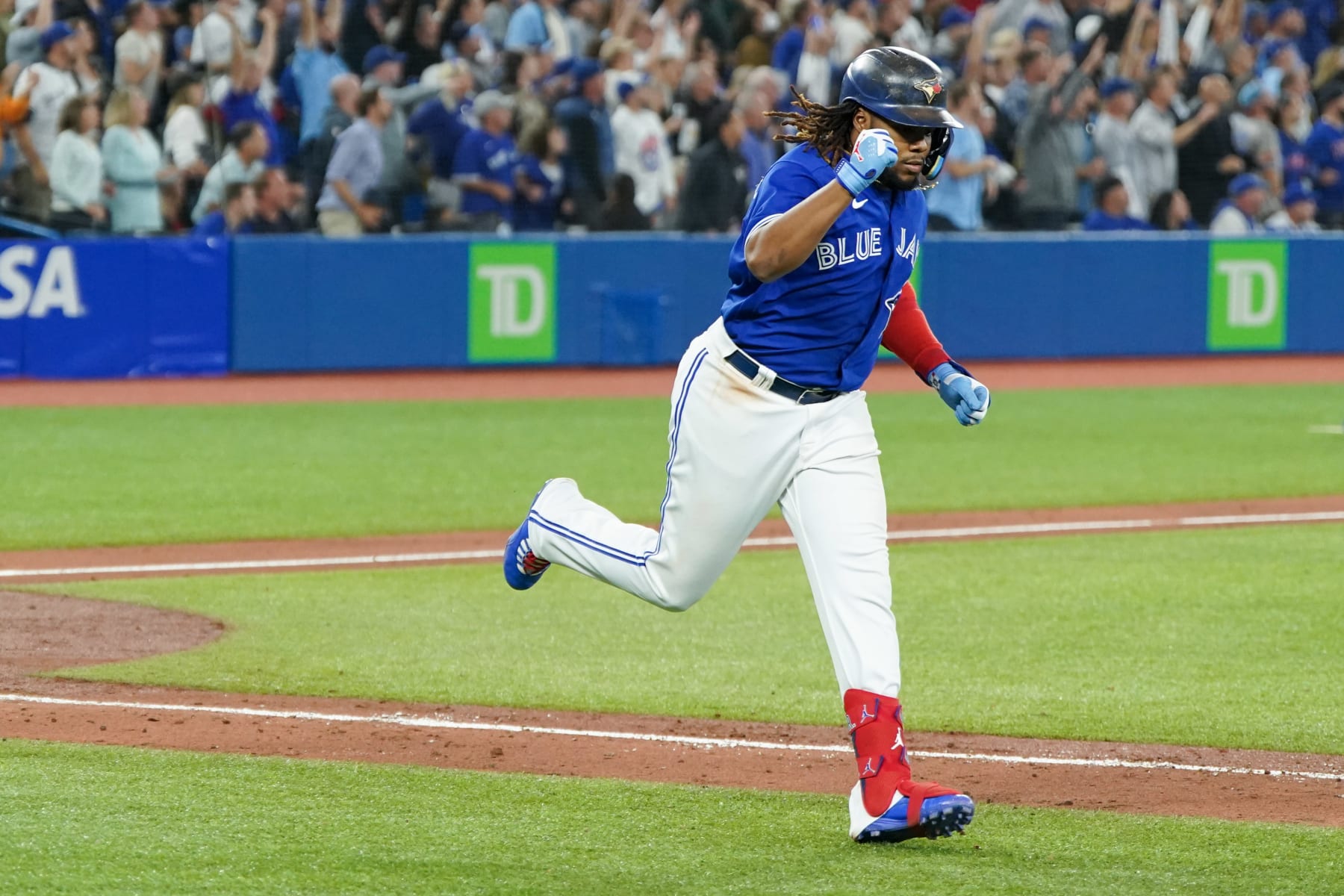 TORONTO,  - SEPTEMBER 28:   Vladimir Guerrero Jr. #27 of the Toronto Blue Jays hits a sacrifice fly in the sixth inning during the game between the New York Yankees and the Toronto Blue Jays at Rogers Centre on Wednesday, September 28, 2022 in Toronto, Canada. (Photo by Thomas Skrlj/MLB Photos via Getty Images)