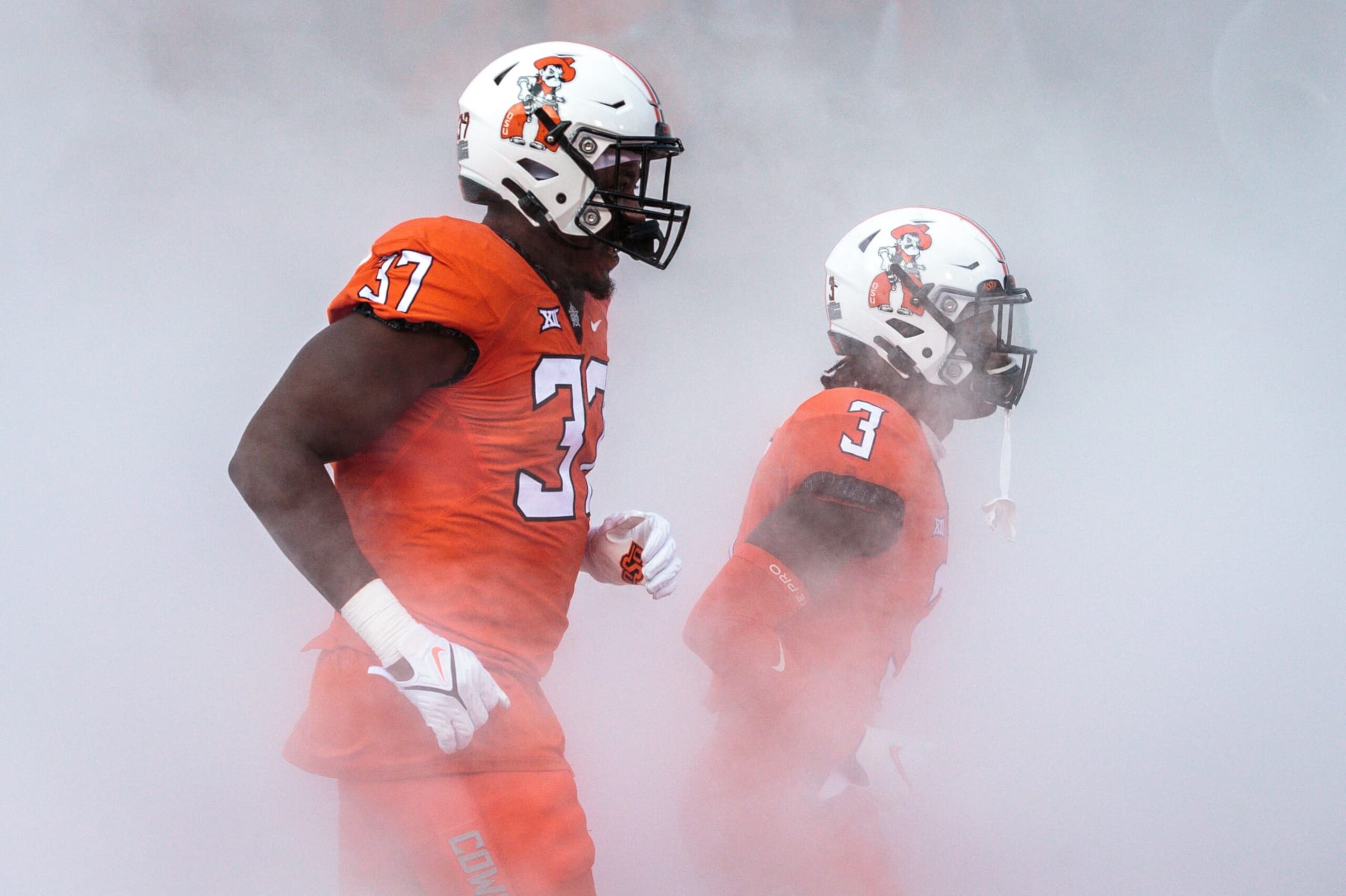 STILLWATER, OK - SEPTEMBER 01: Oklahoma State Cowboys defensive end Isreal Isuman-Hundley (37) and Oklahoma State Cowboys quarterback Spencer Sanders (3) enter the field prior to the game against the Central Michigan Chippewas on September 1st, 2022 at Boone Pickens Stadium in Stillwater, Oklahoma. (Photo by William Purnell/Icon Sportswire via Getty Images)
