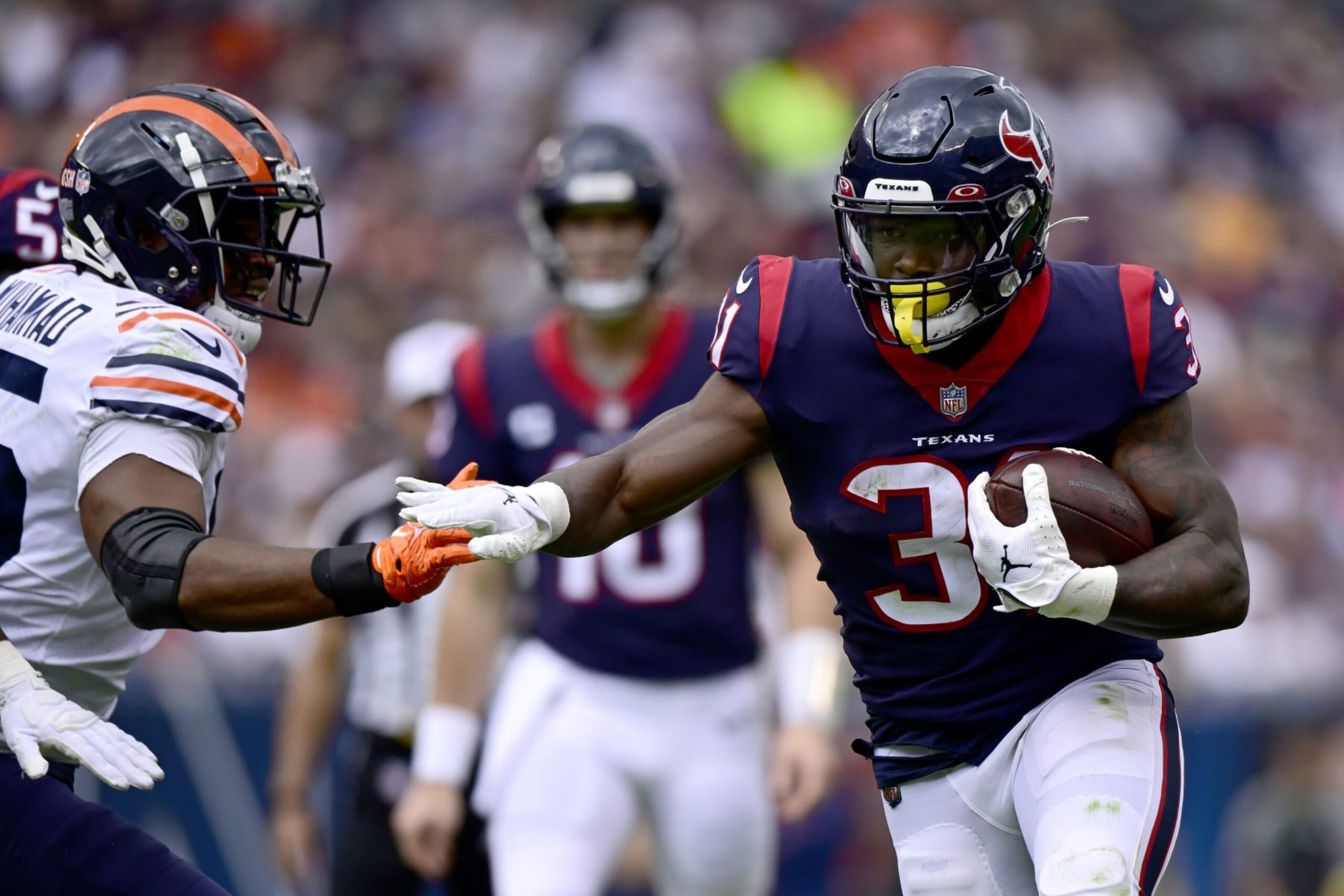 CHICAGO, ILLINOIS - SEPTEMBER 25: Dameon Pierce #31 of the Houston Texans rushes for a first down in the second quarter against the Chicago Bears at Soldier Field on September 25, 2022 in Chicago, Illinois. (Photo by Quinn Harris/Getty Images)