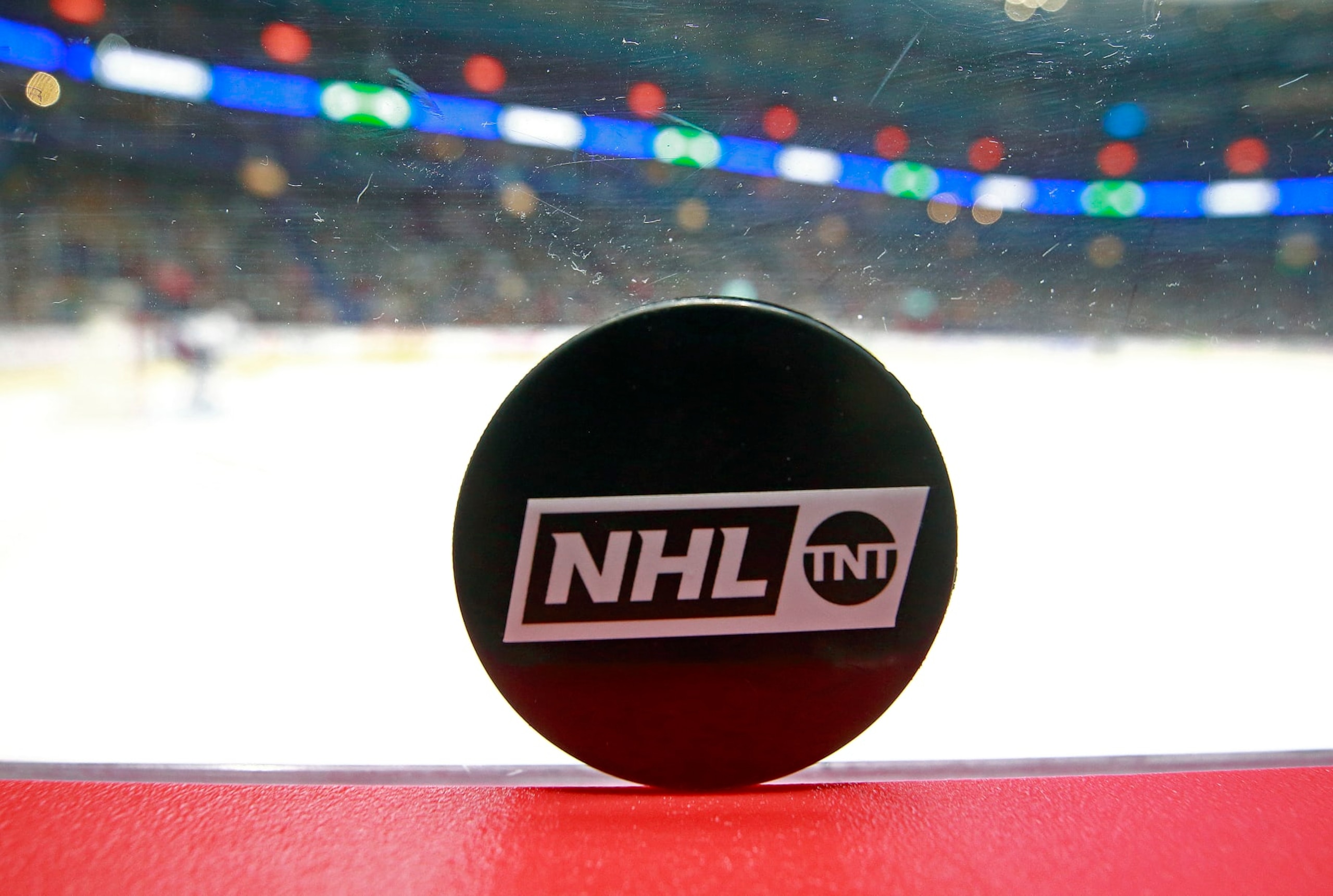VANCOUVER, BC - FEBRUARY 09: A TNT puck sits on the boards during the NHL game between the New York Islanders and the Vancouver Canucks at Rogers Arena February 9, 2022 in Vancouver, British Columbia, Canada. (Photo by Jeff Vinnick/NHLI via Getty Images)"n VANCOUVER, BC - FEBRUARY 09: A TNT puck sits on the boards during the NHL game between the New York Islanders and the Vancouver Canucks at Rogers Arena February 9, 2022 in Vancouver, British Columbia, Canada. (Photo by Jeff Vinnick/NHLI via Getty Images)"n