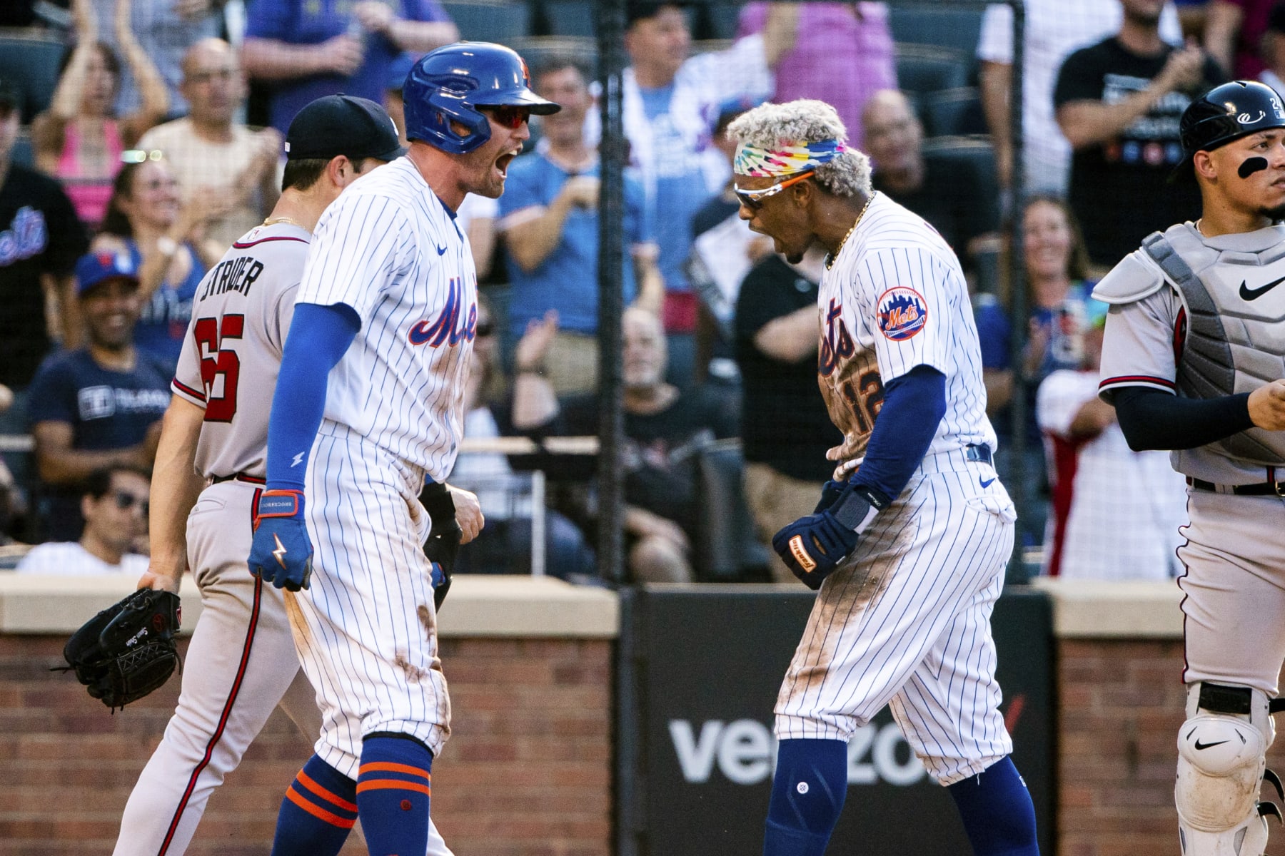New York Mets' Brandon Nimmo and Francisco Lindor celebrate after scoring during the third inning of a baseball game against the Atlanta Braves, Sunday, Aug. 7, 2022, in New York. (AP Photo/Julia Nikhinson)