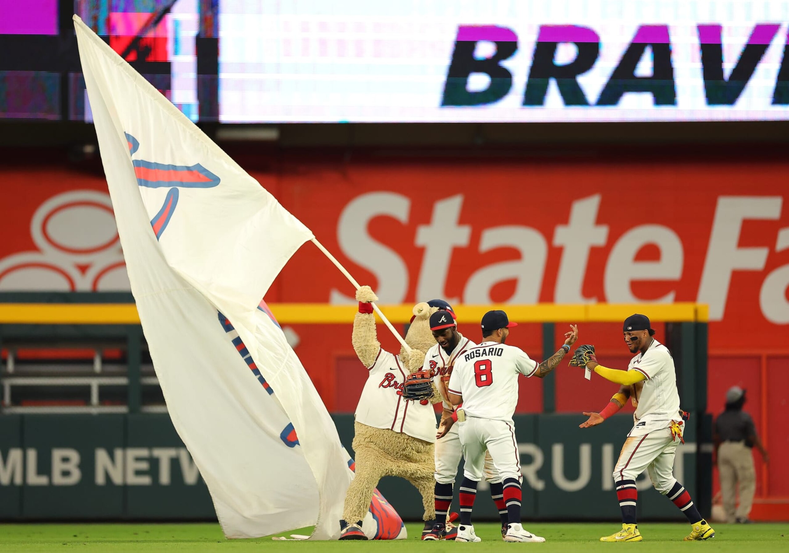 ATLANTA, GEORGIA - SEPTEMBER 19:  Eddie Rosario #8, Michael Harris II #23 and Ronald Acuna Jr. #13 of the Atlanta Braves react after their 5-2 win over the Washington Nationals at Truist Park on September 19, 2022 in Atlanta, Georgia. (Photo by Kevin C. Cox/Getty Images)