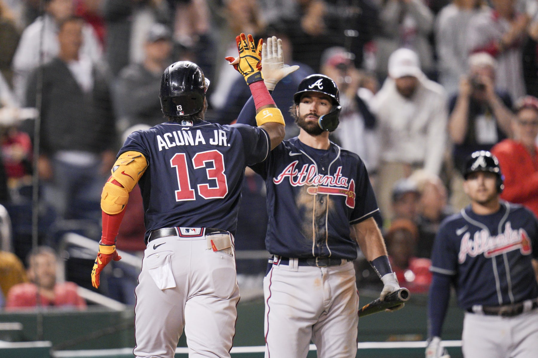 Atlanta Braves' Ronald Acuna Jr. is greeted by Dansby Swanson after hitting a solo home run against the Washington Nationals during the fifth inning of a baseball game at Nationals Park, Tuesday, Sept. 27, 2022, in Washington. (AP Photo/Jess Rapfogel)