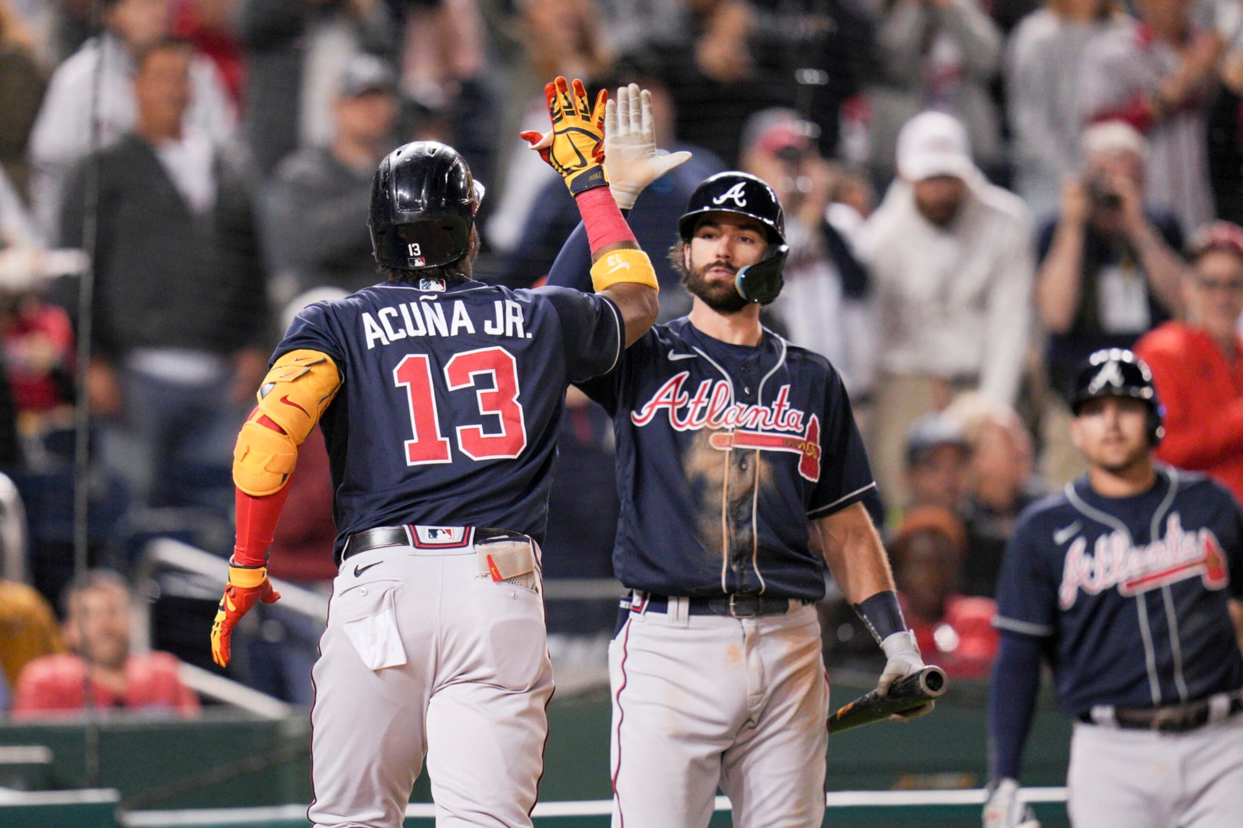 Atlanta Braves' Ronald Acuna Jr. is greeted by Dansby Swanson after hitting a solo home run against the Washington Nationals during the fifth inning of a baseball game at Nationals Park, Tuesday, Sept. 27, 2022, in Washington. (AP Photo/Jess Rapfogel)