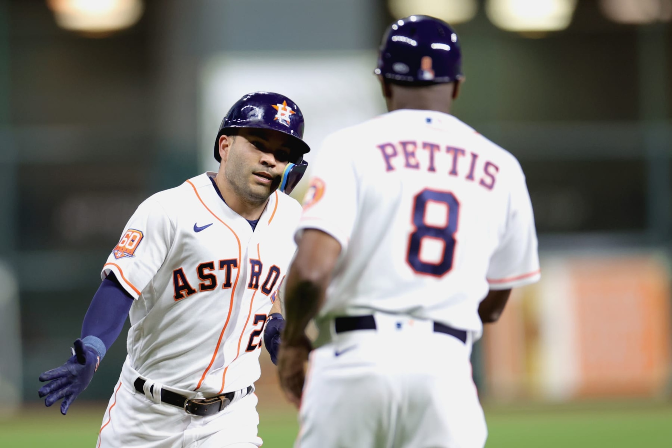 HOUSTON, TEXAS - SEPTEMBER 27: Jose Altuve #27 of the Houston Astros high fives Gary Pettis #8 after hitting a solo home run off Zach Davies #27 of the Arizona Diamondbacks during the first inning at Minute Maid Park on September 27, 2022 in Houston, Texas. (Photo by Carmen Mandato/Getty Images)