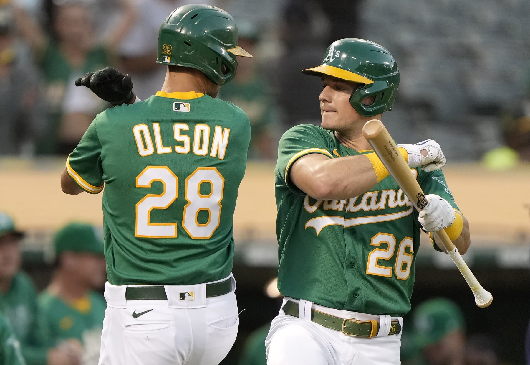 OAKLAND, CALIFORNIA - SEPTEMBER 21: Matt Olson #28 and Matt Chapman #26 of the Oakland Athletics celebrate after Olson hit a solo home run against the Seattle Mariners in the bottom of the first inning at RingCentral Coliseum on September 21, 2021 in Oakland, California. (Photo by Thearon W. Henderson/Getty Images)