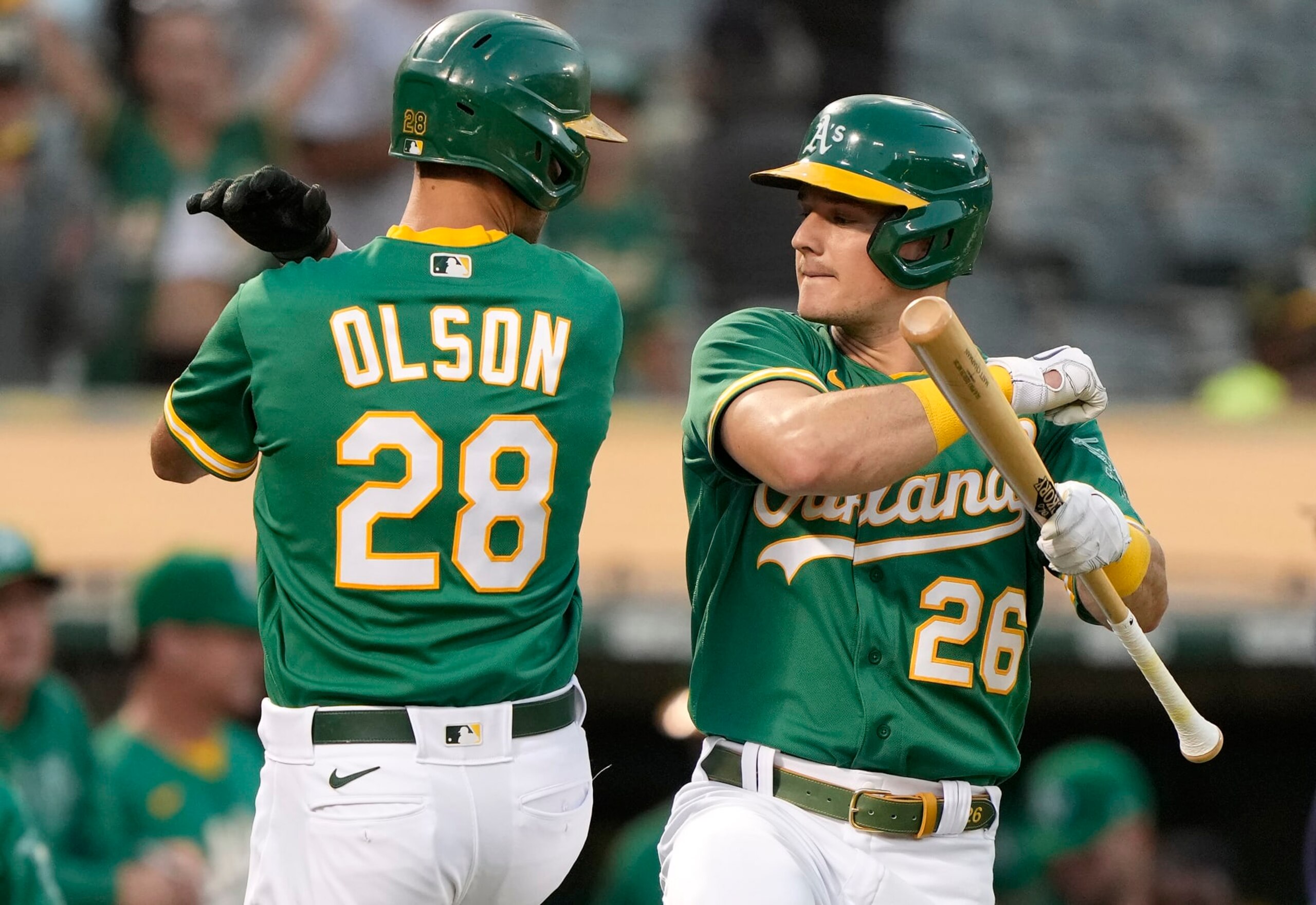 OAKLAND, CALIFORNIA - SEPTEMBER 21: Matt Olson #28 and Matt Chapman #26 of the Oakland Athletics celebrate after Olson hit a solo home run against the Seattle Mariners in the bottom of the first inning at RingCentral Coliseum on September 21, 2021 in Oakland, California. (Photo by Thearon W. Henderson/Getty Images)