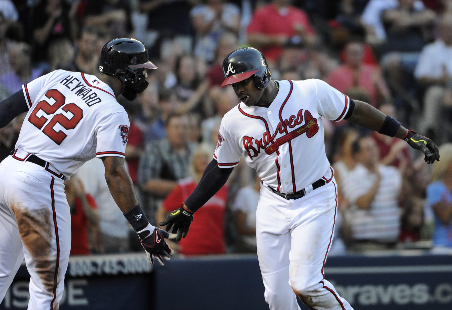 Atlanta Braves' Justin Upton, right, celebrates with Jason Heyward after Upton hit a solo home run against the Miami Marlins during the third inning of a baseball game Tuesday, July 22, 2014, in Atlanta. (AP Photo/David Tulis)