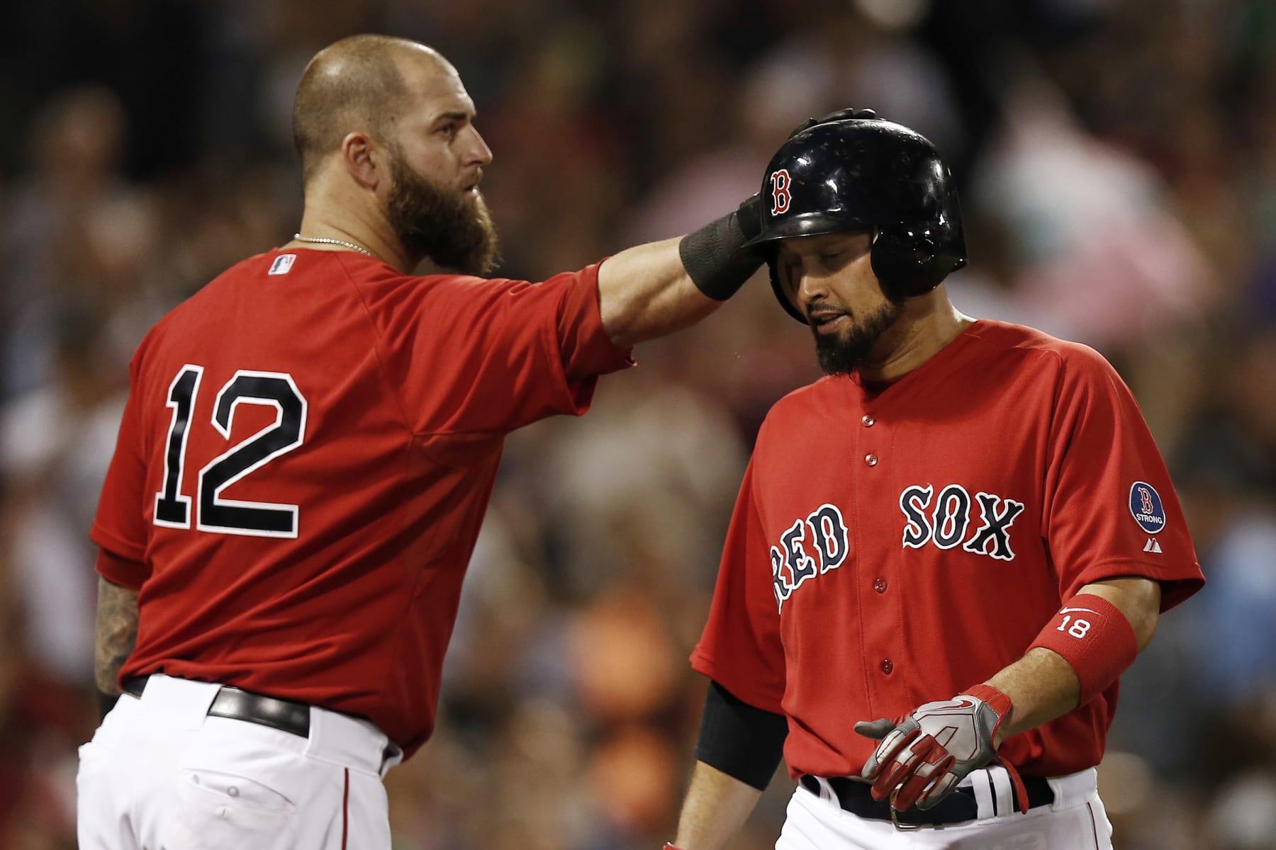 BOSTON, MA - AUGUST 30:  Shane Victorino #18 of the Boston Red Sox is tapped on the helmet by teammate Mike Napoli #12 after scoring during the fourth inning against the Chicago White Sox at Fenway Park on August 30, 2013 in Boston, Massachusetts.  (Photo by Winslow Townson/Getty Images)