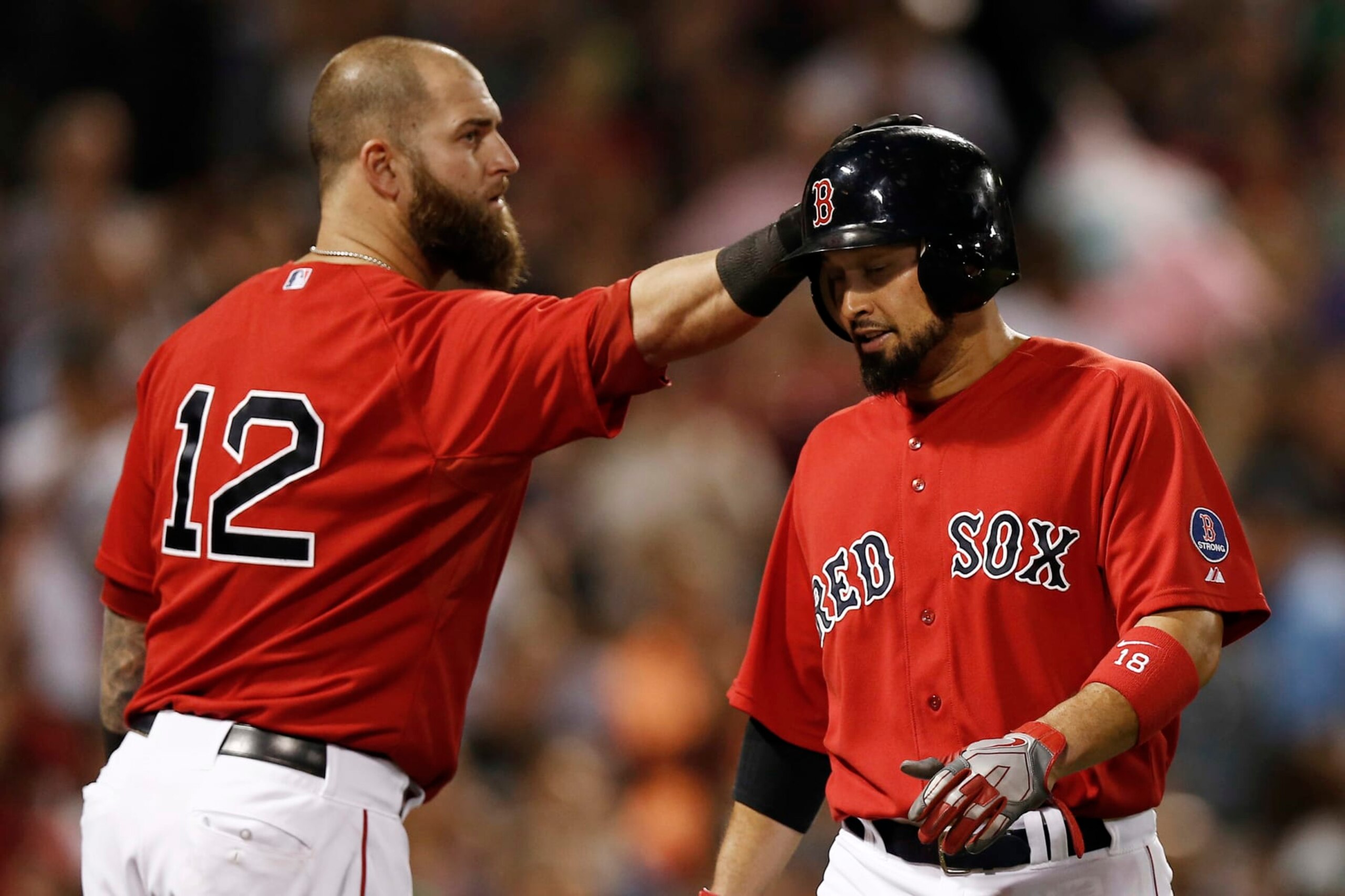 BOSTON, MA - AUGUST 30:  Shane Victorino #18 of the Boston Red Sox is tapped on the helmet by teammate Mike Napoli #12 after scoring during the fourth inning against the Chicago White Sox at Fenway Park on August 30, 2013 in Boston, Massachusetts.  (Photo by Winslow Townson/Getty Images)