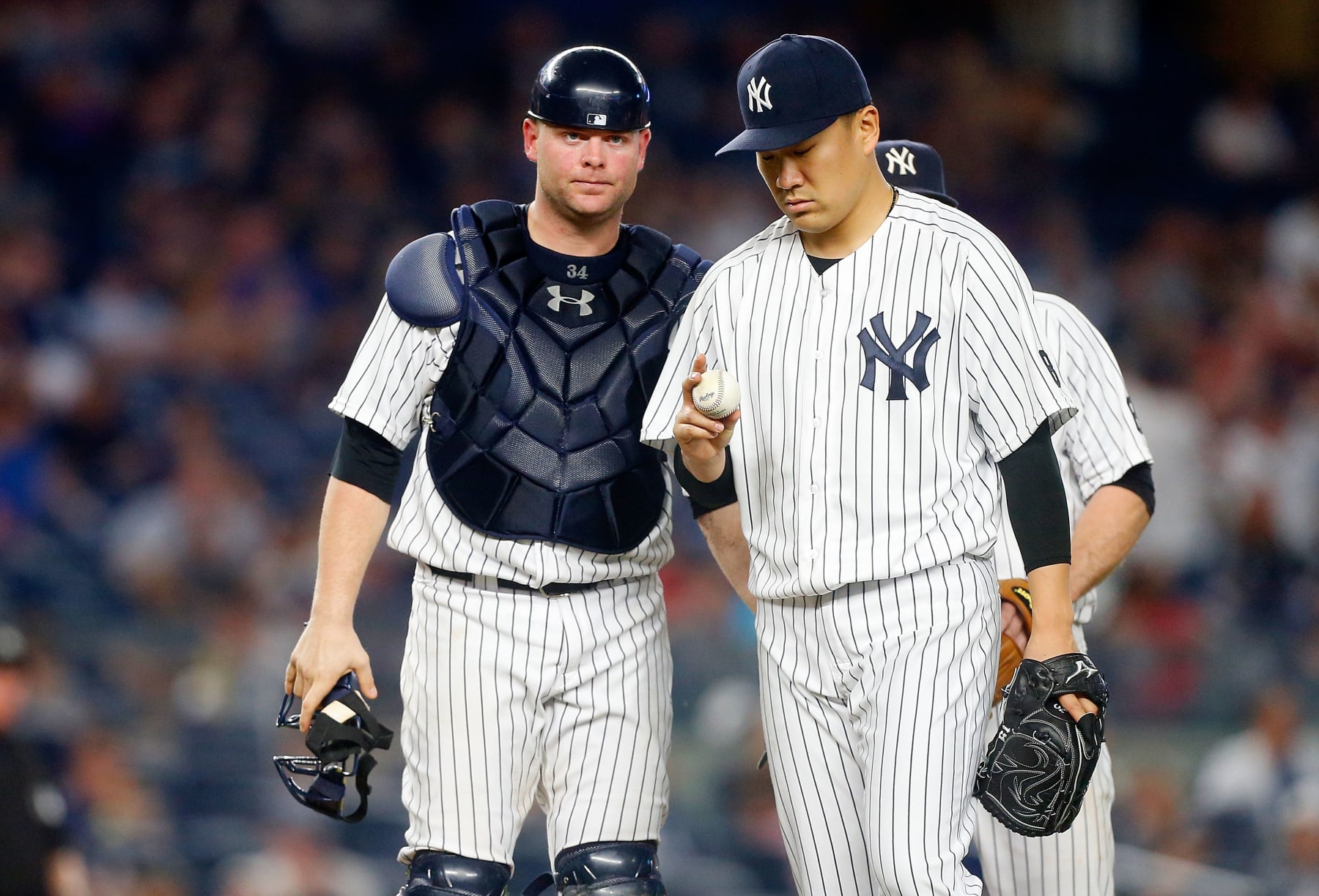 NEW YORK, NY - JUNE 11:  Masahiro Tanaka #19 of the New York Yankees stands on the mound with teammate Brian McCann #34 before leaving a game in the seventh inning against the Detroit Tigers at Yankee Stadium on June 11, 2016 in the Bronx borough of New York City. The Tigers defeated the Yankees 6-1.  (Photo by Jim McIsaac/Getty Images)