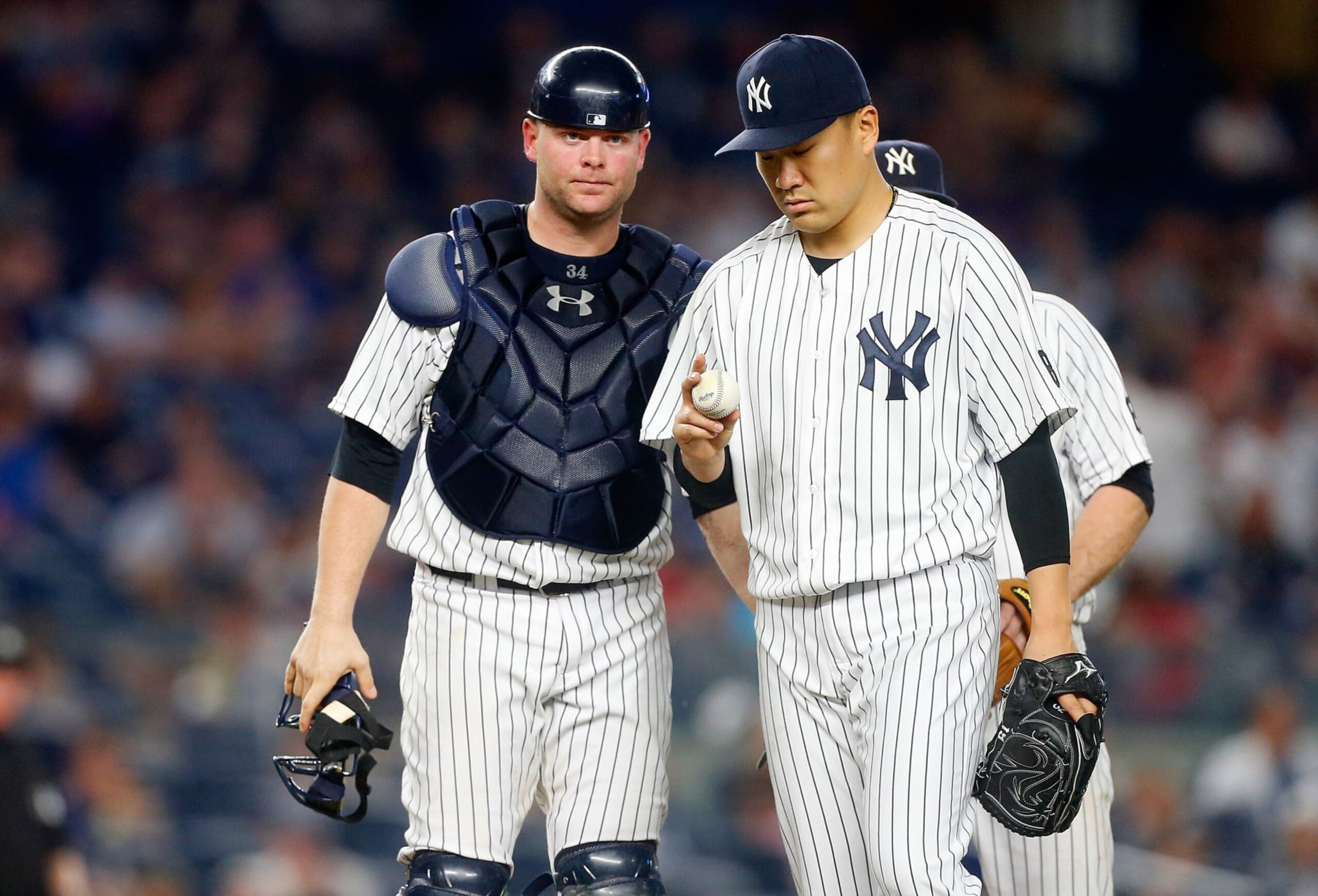 NEW YORK, NY - JUNE 11:  Masahiro Tanaka #19 of the New York Yankees stands on the mound with teammate Brian McCann #34 before leaving a game in the seventh inning against the Detroit Tigers at Yankee Stadium on June 11, 2016 in the Bronx borough of New York City. The Tigers defeated the Yankees 6-1.  (Photo by Jim McIsaac/Getty Images)