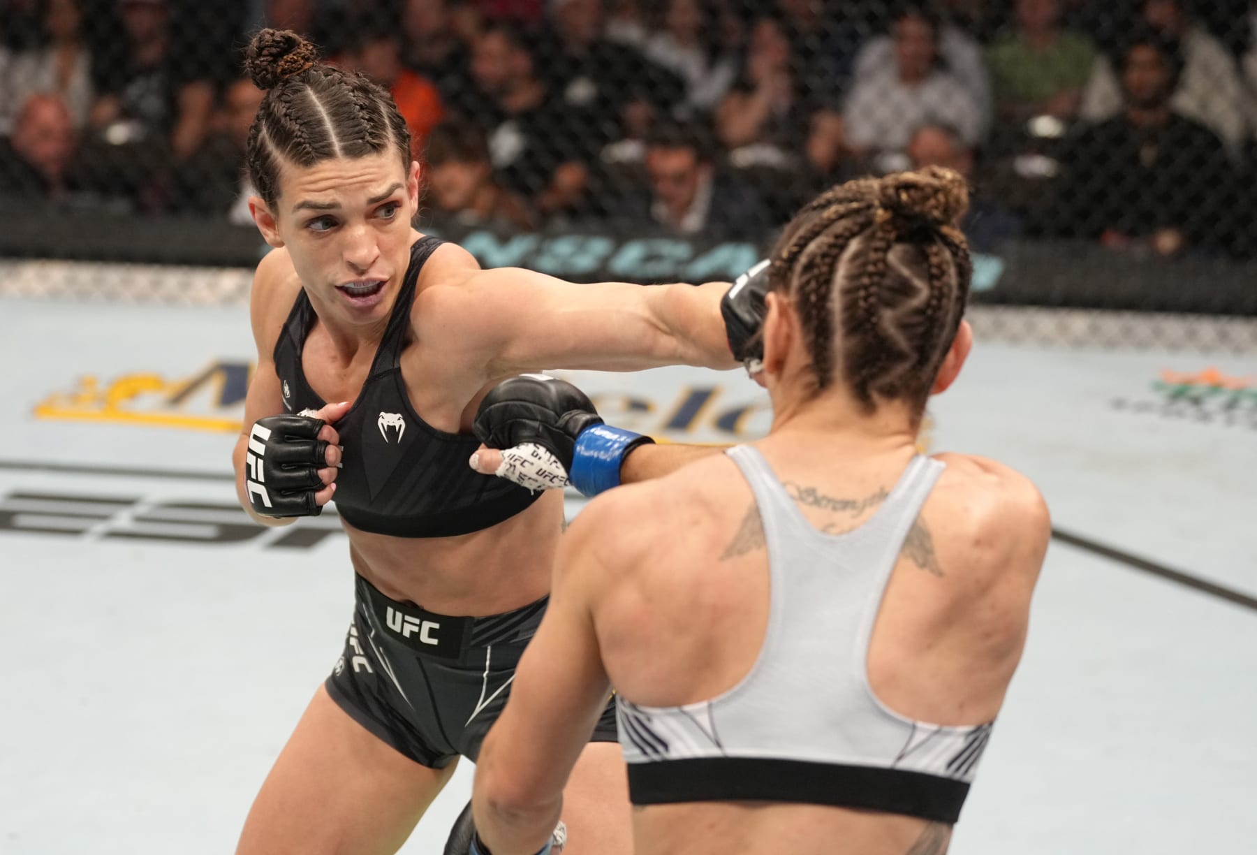 JACKSONVILLE, FLORIDA - APRIL 09: (L-R) Mackenzie Dern punches Tecia Torres in their strawweight fight during the UFC 273 event at VyStar Veterans Memorial Arena on April 09, 2022 in Jacksonville, Florida. (Photo by Jeff Bottari/Zuffa LLC)