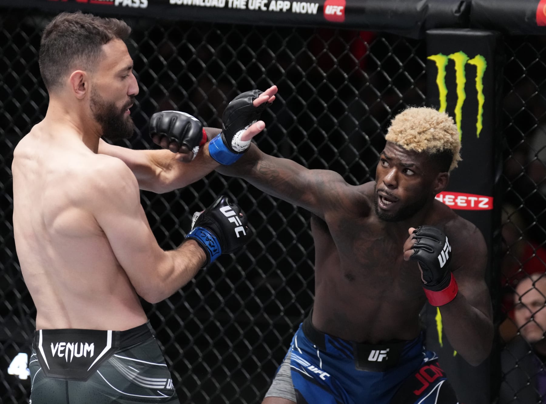 LAS VEGAS, NEVADA - MARCH 12: (R-L) Trevin Jones of Guam punches Javid Basharat of England in their bantamweight fight during the UFC Fight Night event at UFC APEX on March 12, 2022 in Las Vegas, Nevada. (Photo by Chris Unger/Zuffa LLC)