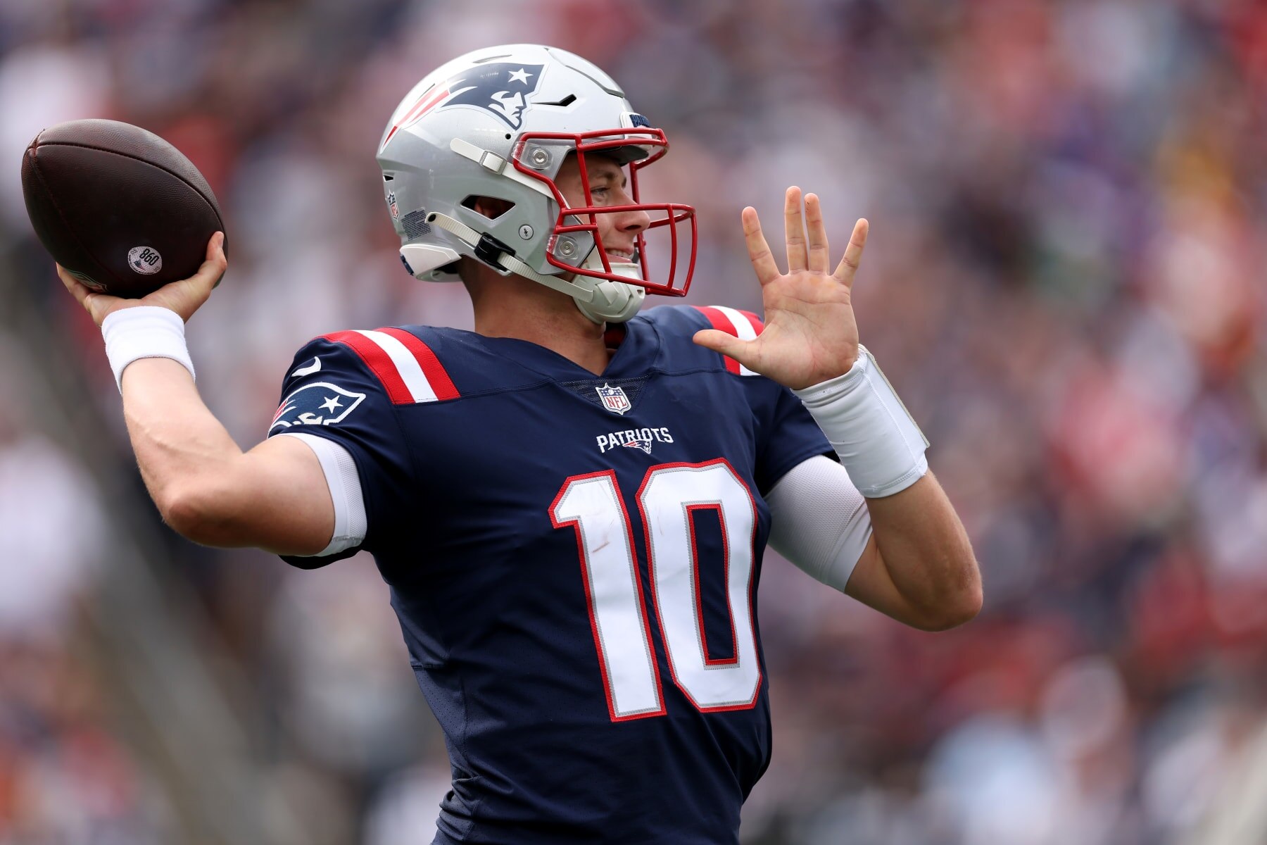 FOXBOROUGH, MASSACHUSETTS - SEPTEMBER 25:Mac Jones #10 of the New England Patriots throws while warming up during the game against the Baltimore Ravens at Gillette Stadium on September 25, 2022 in Foxborough, Massachusetts. (Photo by Maddie Meyer/Getty Images)