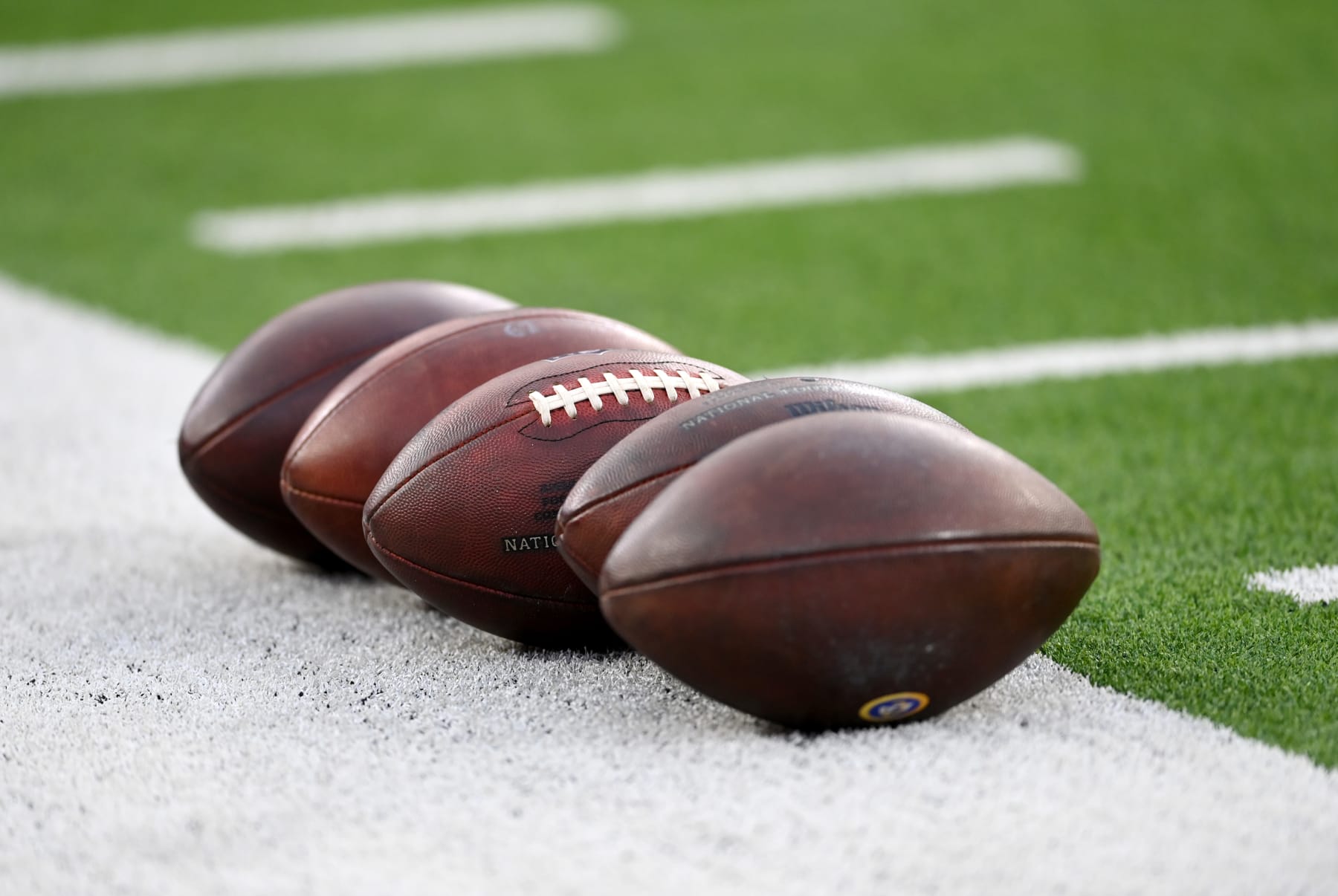 INGLEWOOD, CA - DECEMBER 21: NFL footballs are lined up on the field before the game between the Los Angeles Rams and the Seattle Seahawks at SoFi Stadium on December 19, 2021 in Inglewood, California. (Photo by Jayne Kamin-Oncea/Getty Images)