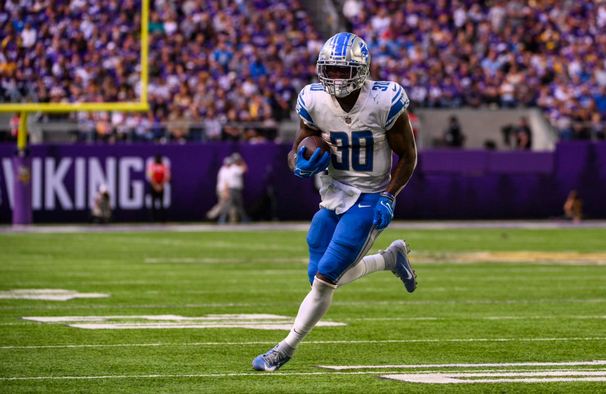 MINNEAPOLIS, MN - SEPTEMBER 25: Jamaal Williams #30 of the Detroit Lions runs with the ball in the third quarter of the game against the Minnesota Vikings at U.S. Bank Stadium on September 25, 2022 in Minneapolis, Minnesota. (Photo by Stephen Maturen/Getty Images)
