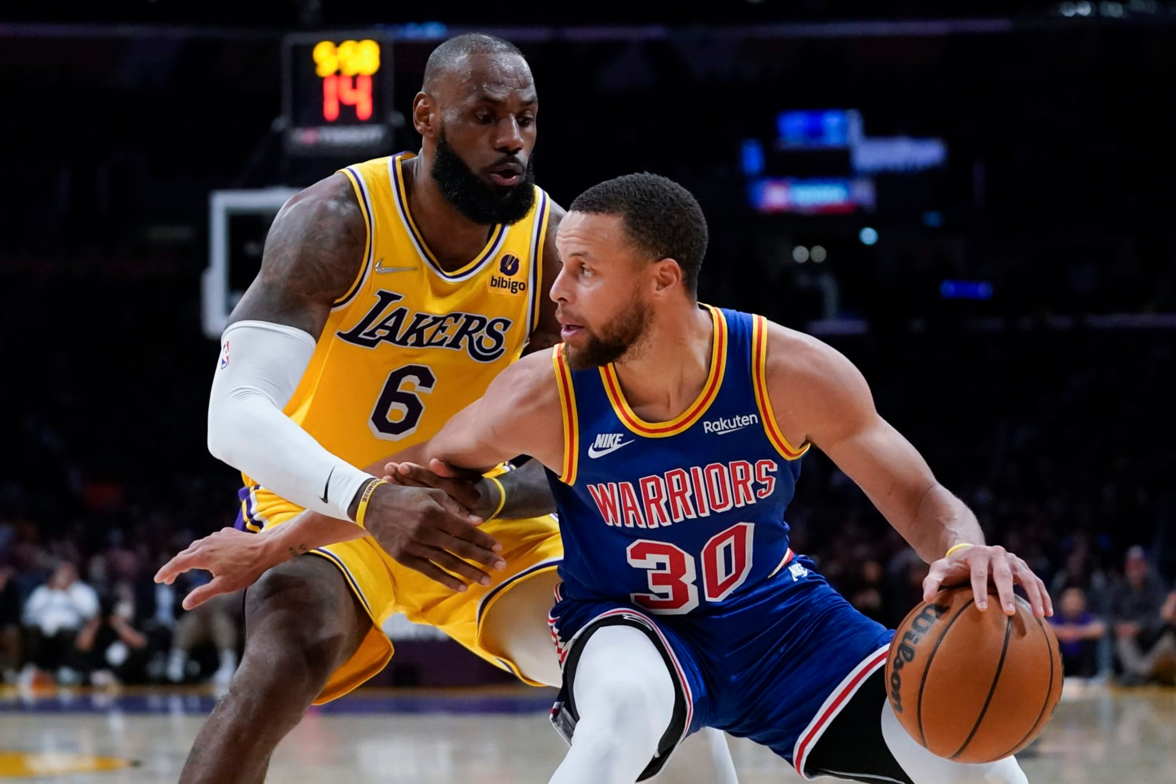 Los Angeles Lakers forward LeBron James (6) defends against Golden State Warriors guard Stephen Curry (30) during the second half of an NBA basketball game in Los Angeles, Saturday, March 5, 2022. (AP Photo/Ashley Landis)